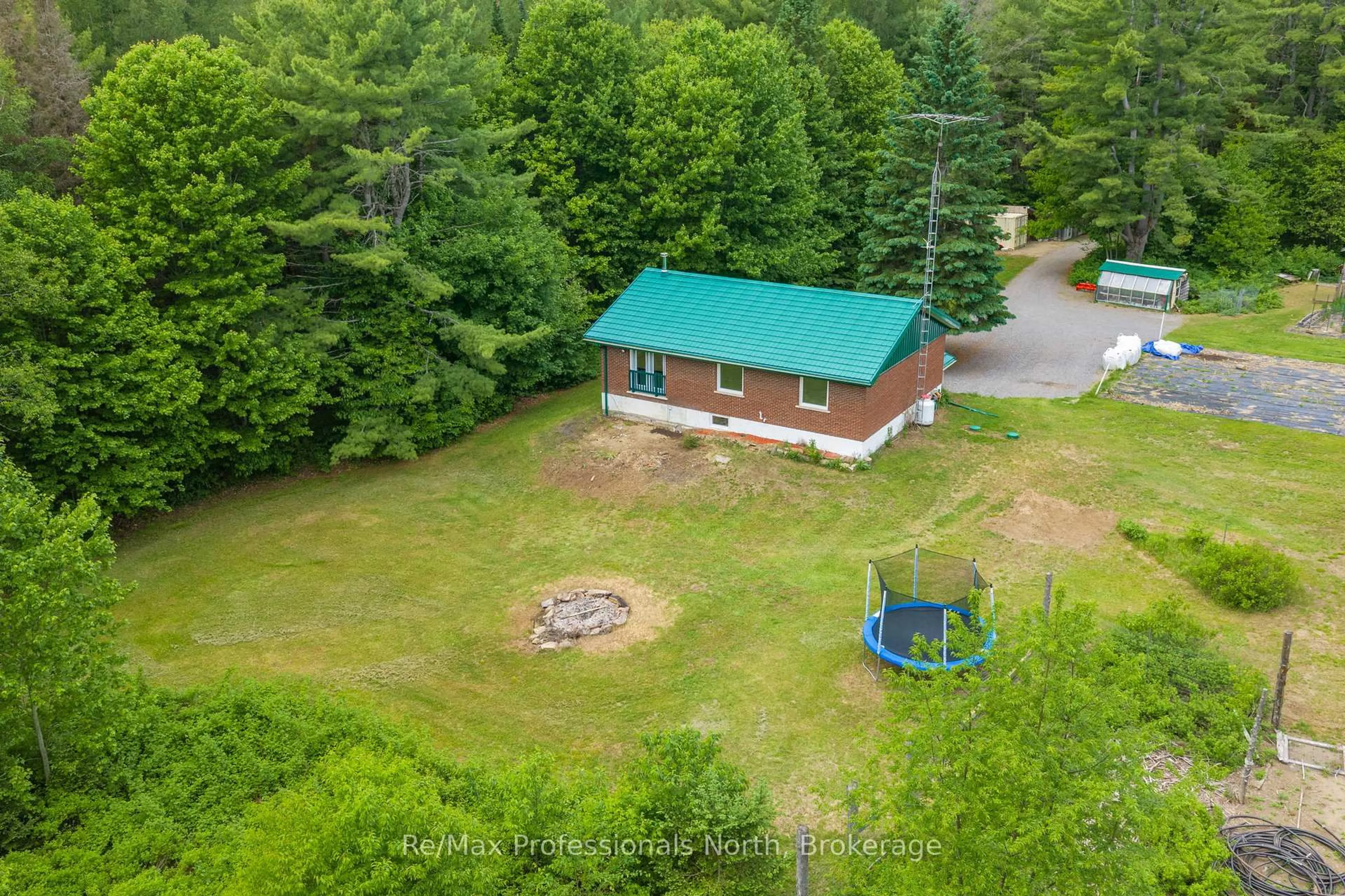 A pic from outside/outdoor area/front of a property/back of a property/a pic from drone, forest/trees view for 163 Rose Lake Rd, Huntsville Ontario P0B 1M0