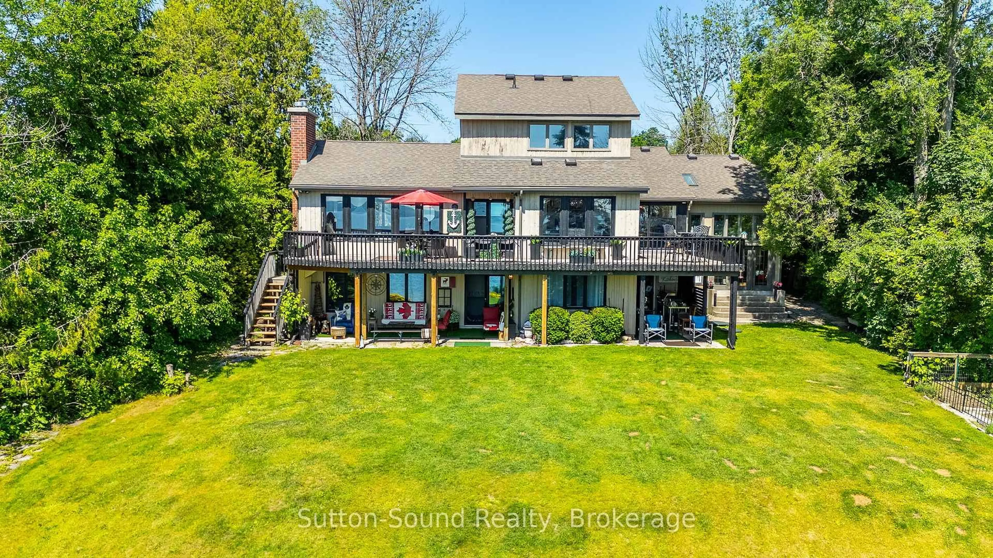 A pic from outside/outdoor area/front of a property/back of a property/a pic from drone, water/lake/river/ocean view for 427 Balmy Beach Rd, Georgian Bluffs Ontario N4K 5N4