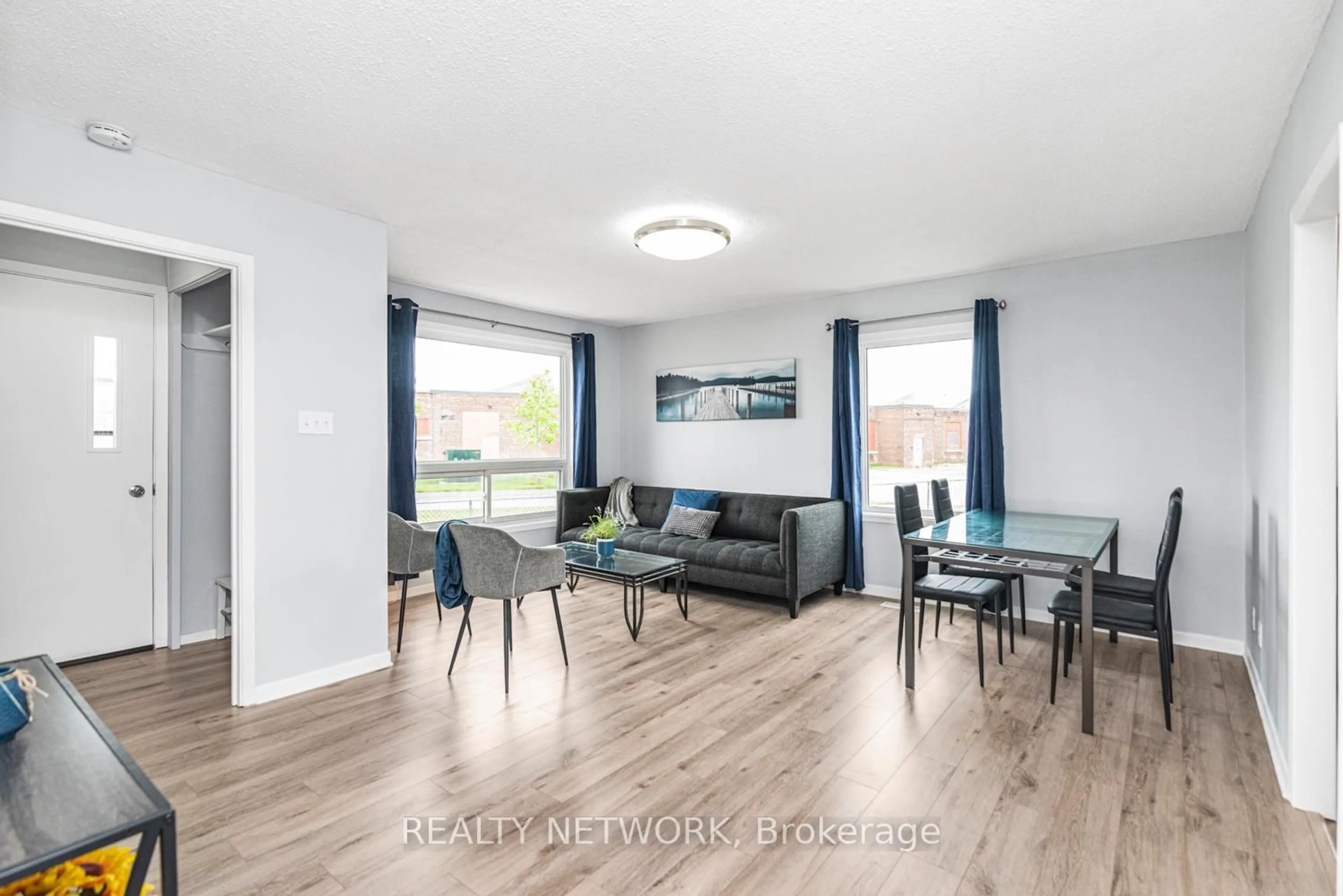Living room with furniture, wood/laminate floor for 168 Berryman Ave, St. Catharines Ontario L2R 3X1