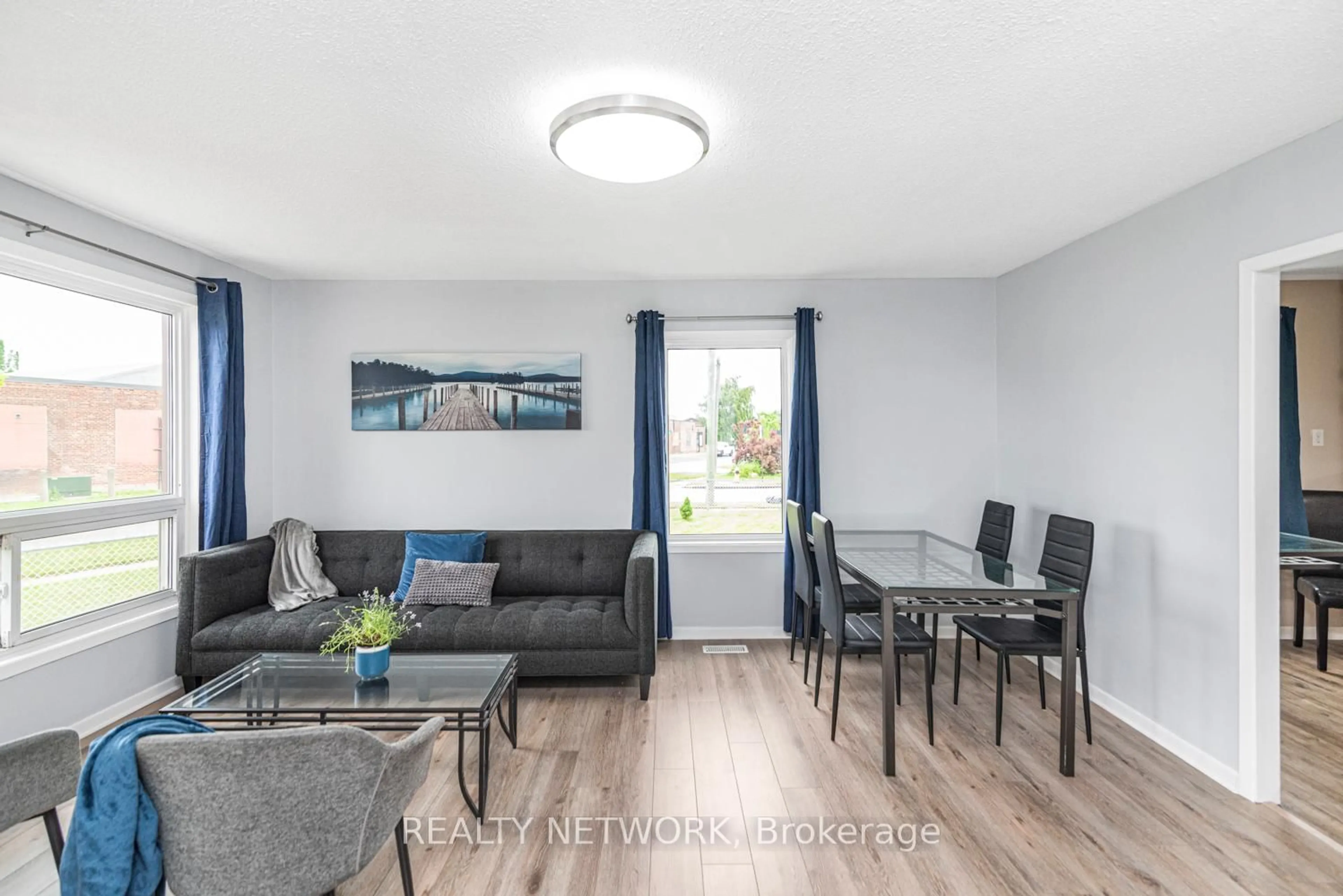 Living room with furniture, wood/laminate floor for 168 Berryman Ave, St. Catharines Ontario L2R 3X1