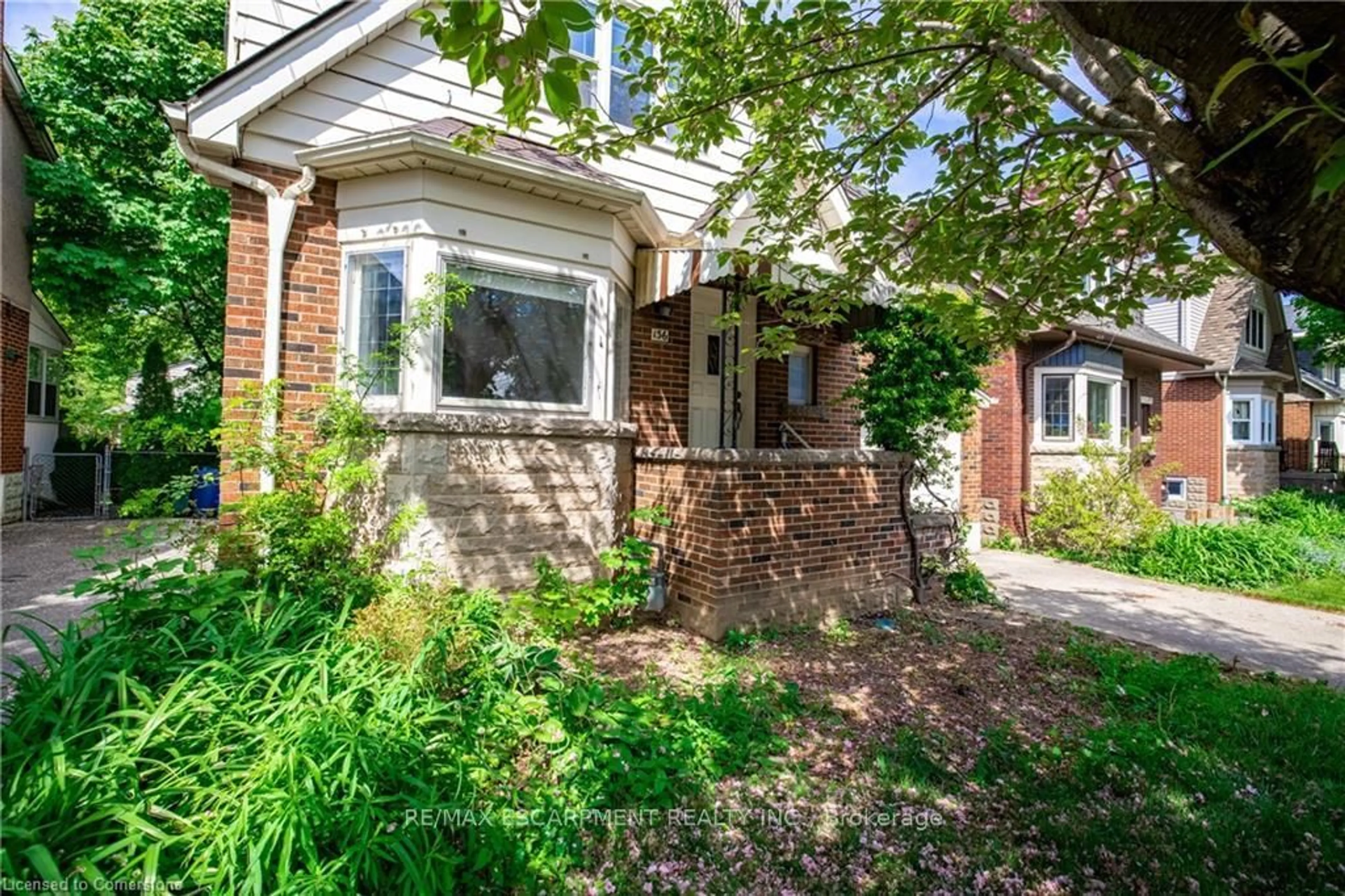 Home with brick exterior material, street for 136 Glen Rd, Hamilton Ontario L8S 3M9