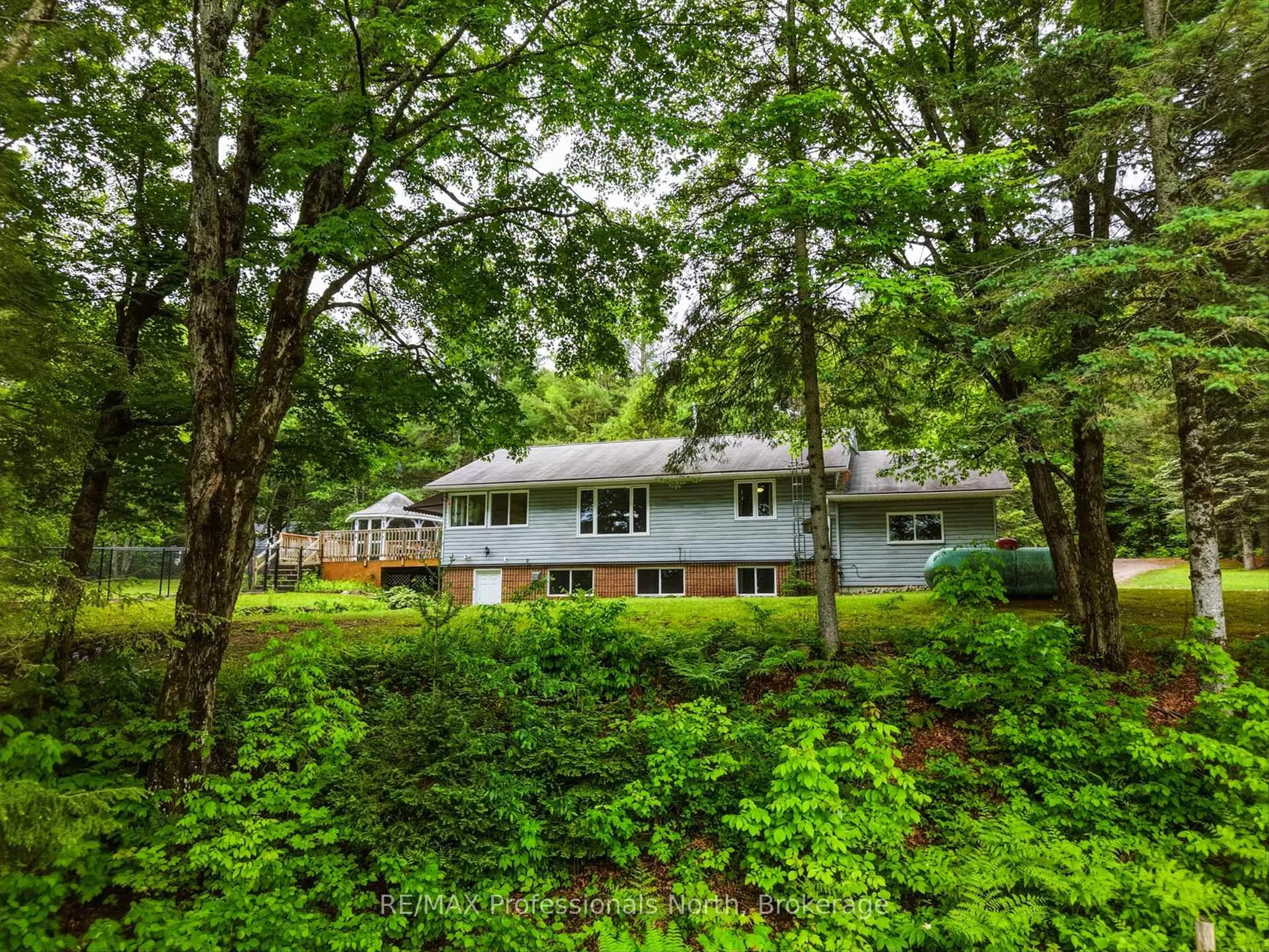 A pic from outside/outdoor area/front of a property/back of a property/a pic from drone, forest/trees view for 1020 COLONY Rd, Bracebridge Ontario P1L 1X3