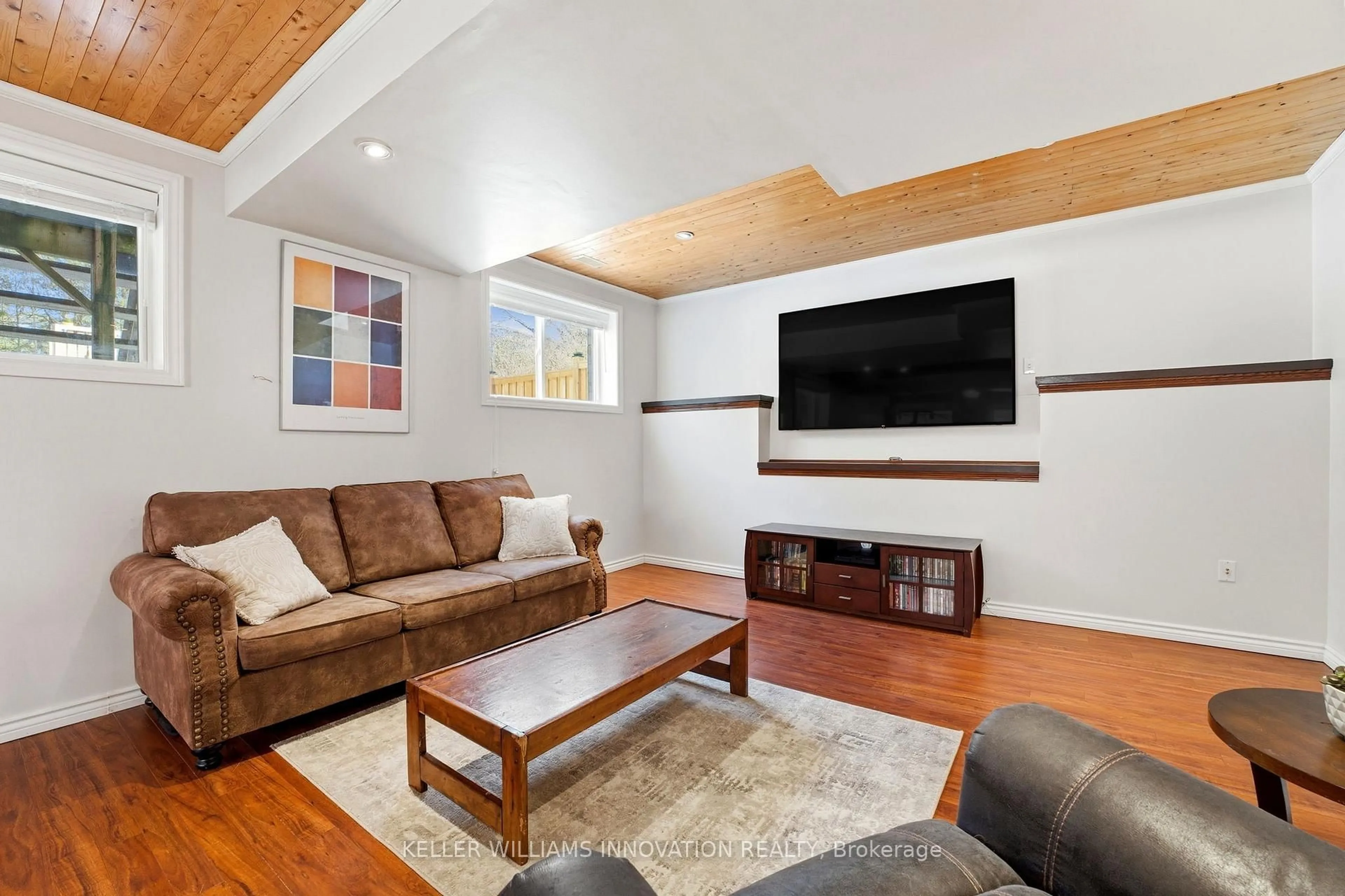 Living room with furniture, wood/laminate floor for 765 Reid Cres, North Perth Ontario N4W 0A2