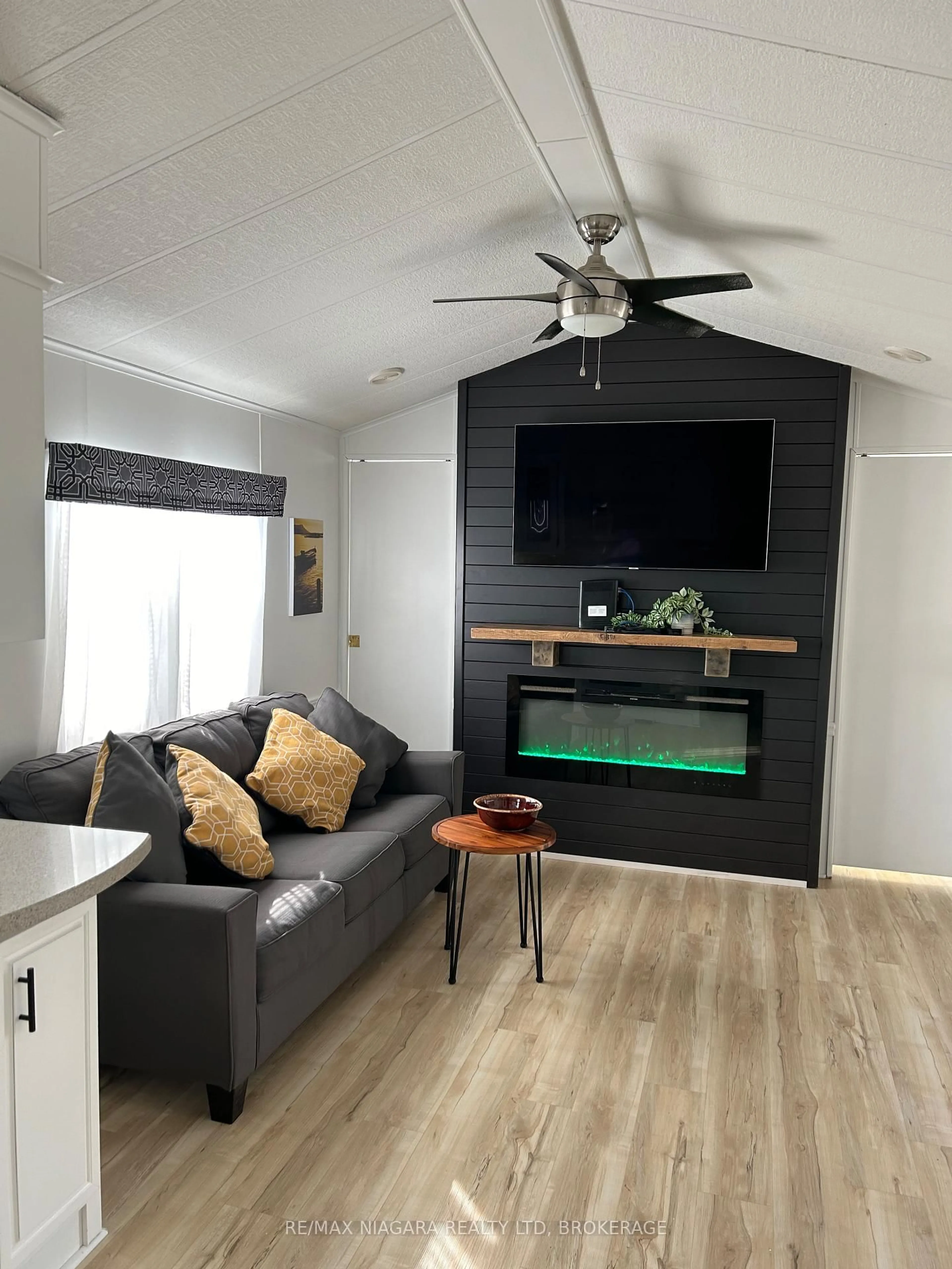 Living room with furniture, wood/laminate floor for 48 Quarry View Village, Port Colborne Ontario L0S 1R0