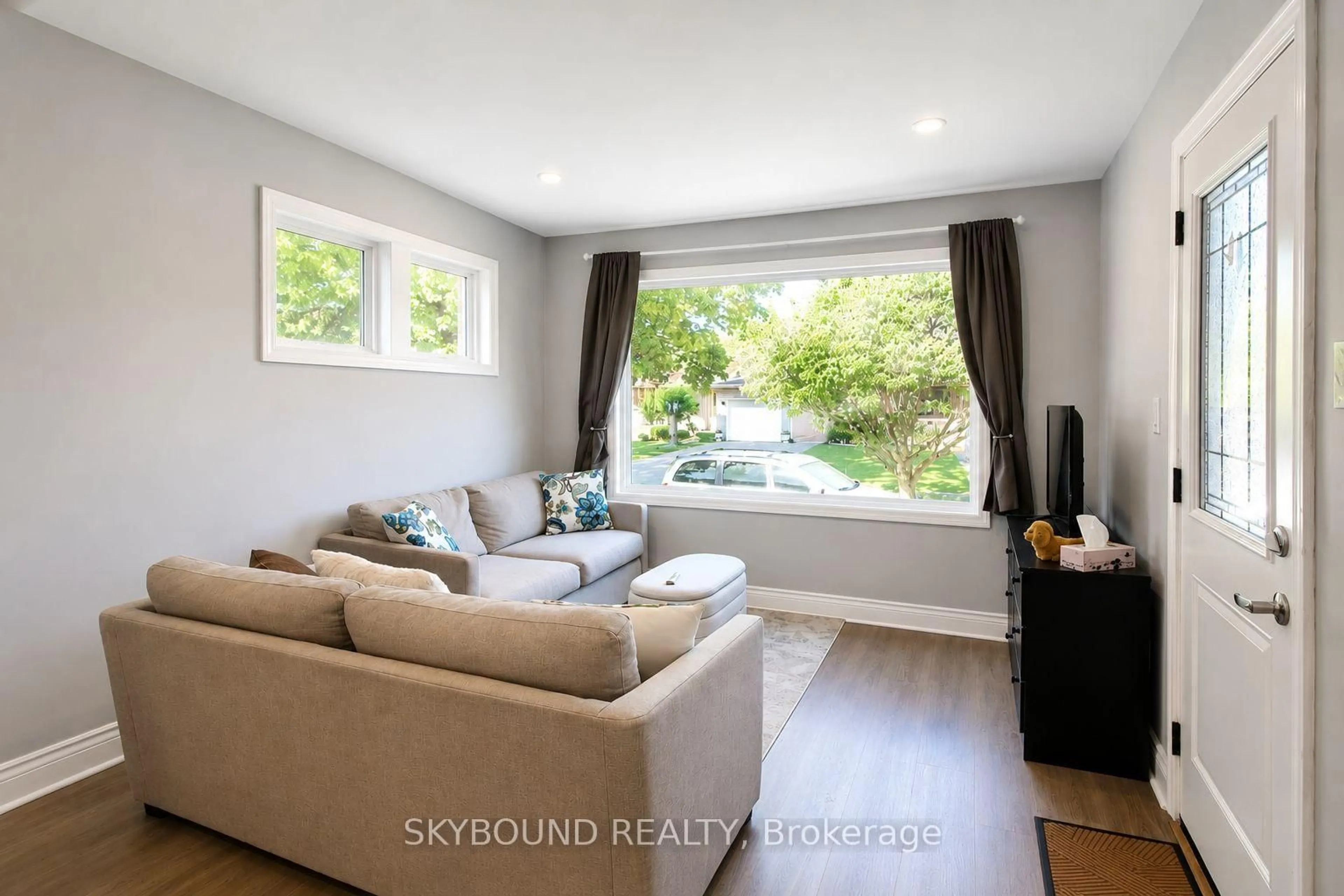 Living room with furniture, wood/laminate floor for 1723 Langlois Ave, Windsor Ontario N8X 4M4