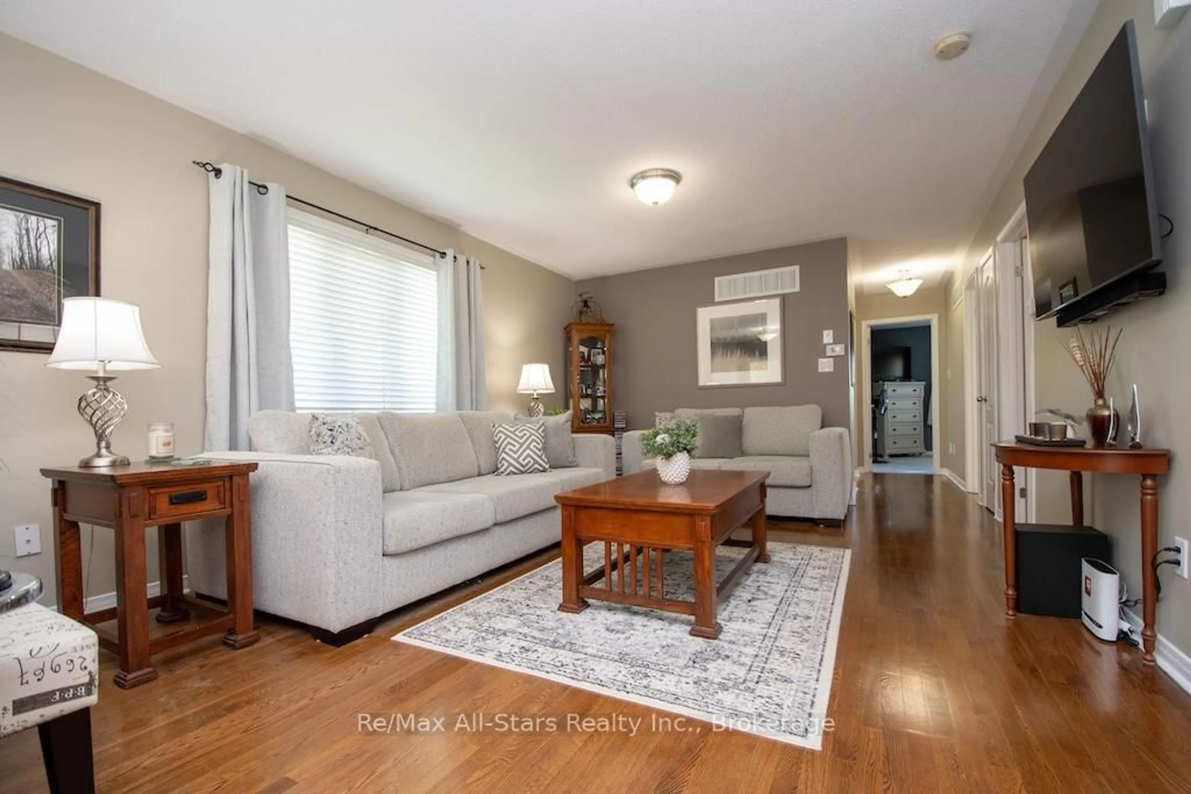 Living room with furniture, wood/laminate floor for 72 Cook St, Kawartha Lakes Ontario K9V 0C7