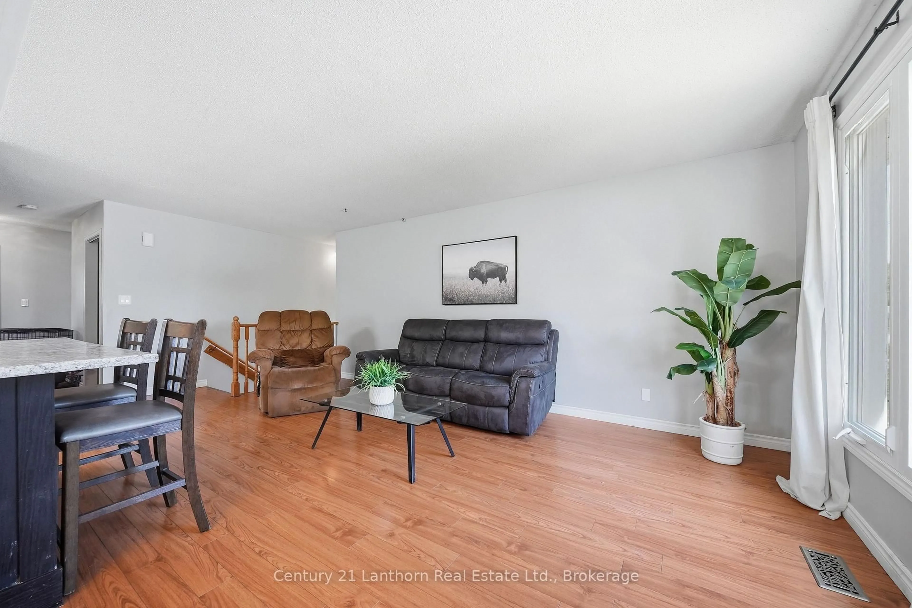 Living room with furniture, wood/laminate floor for 38 Alfred St, Quinte West Ontario K8V 2B1