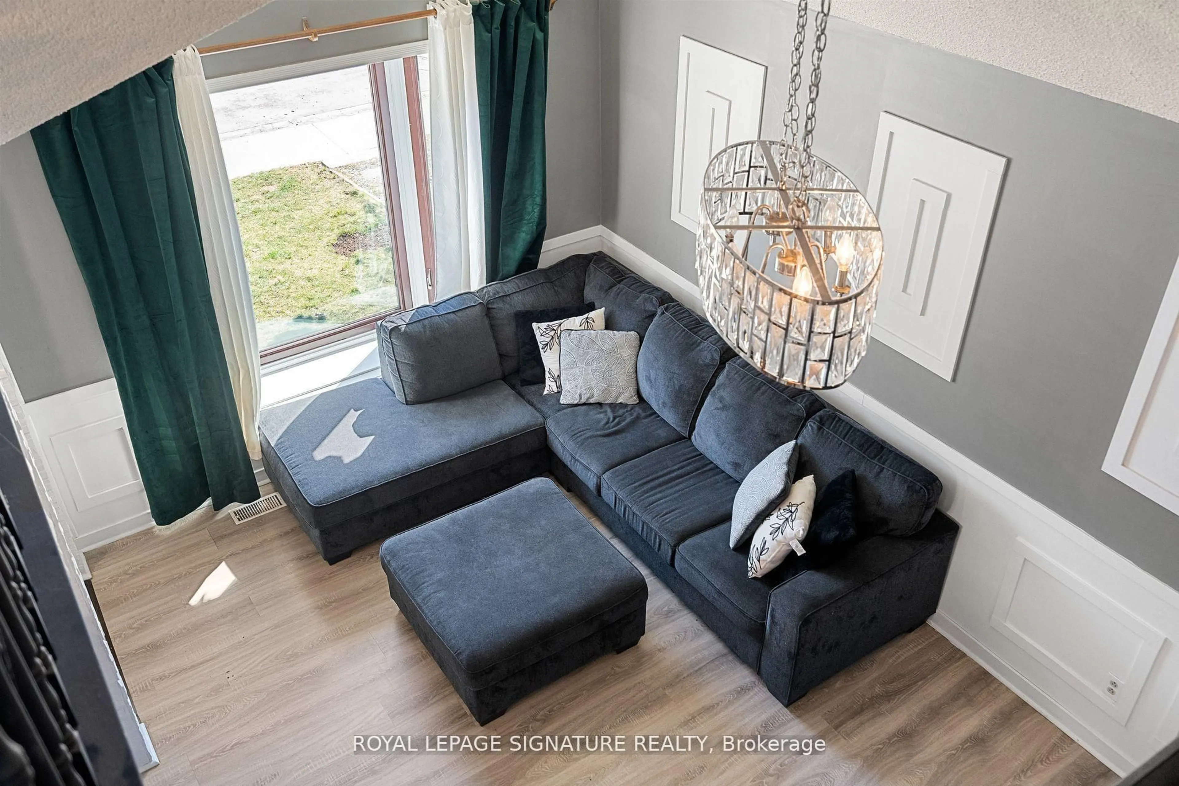 Living room with furniture, wood/laminate floor for 63 Lowell Ave, St. Catharines Ontario L5N 0B3
