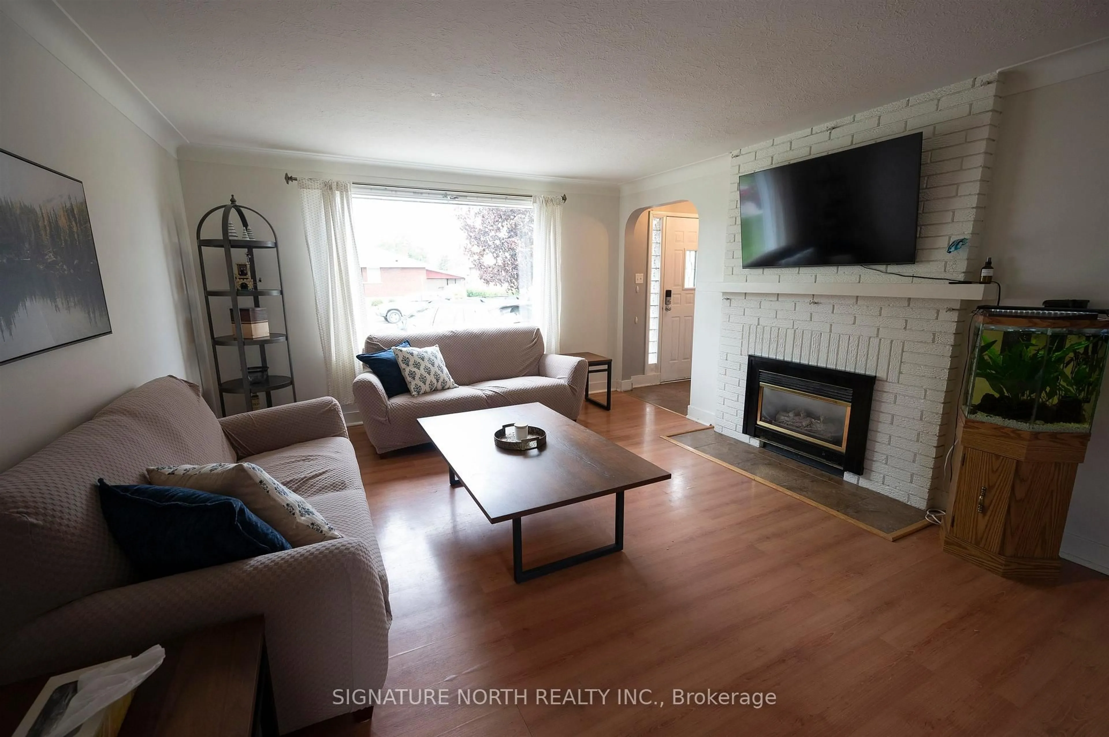 Living room with furniture, wood/laminate floor for 2018 Donald Street East, Thunder Bay Ontario P7E 5W8