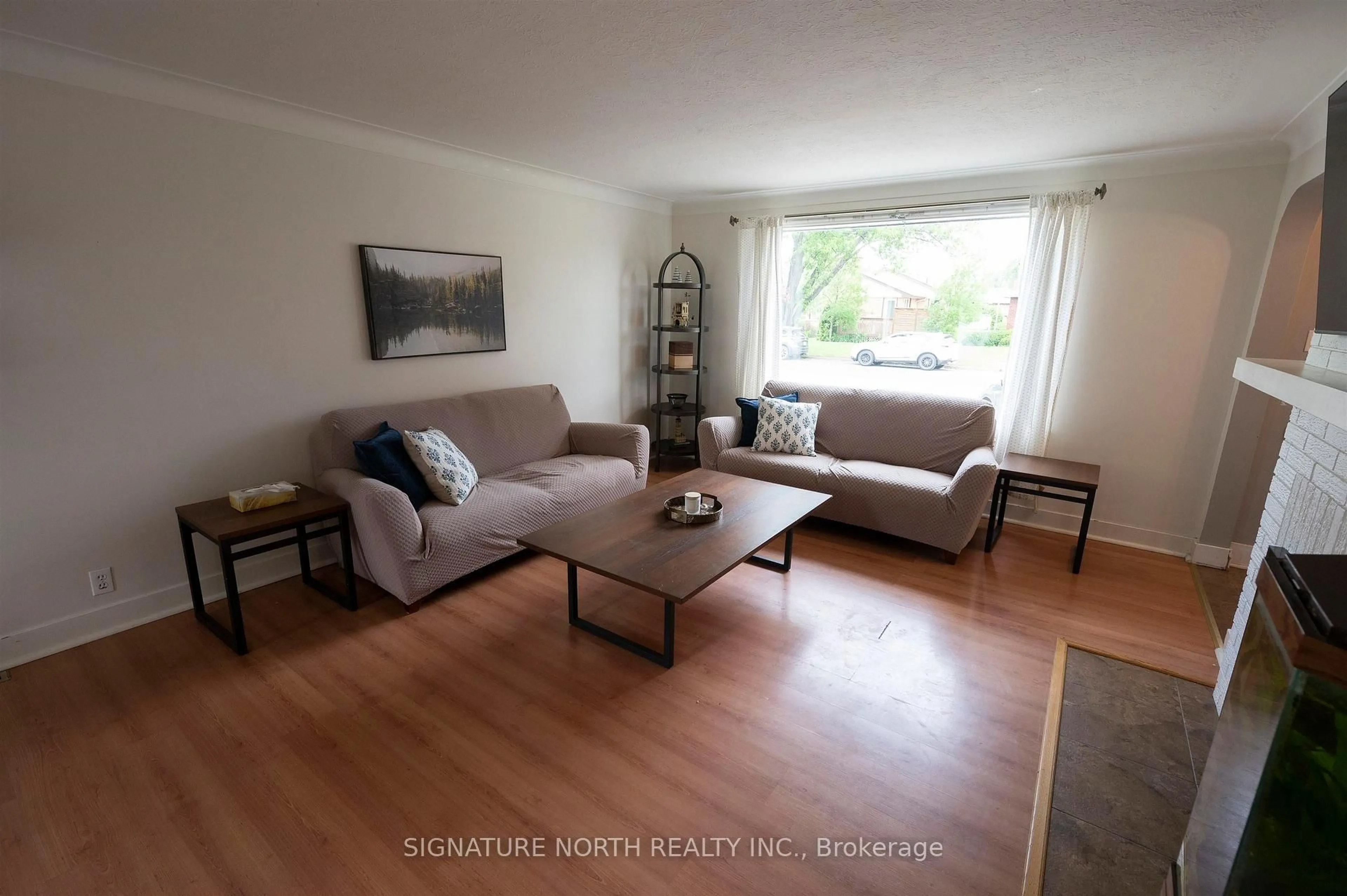 Living room with furniture, wood/laminate floor for 2018 Donald Street East, Thunder Bay Ontario P7E 5W8