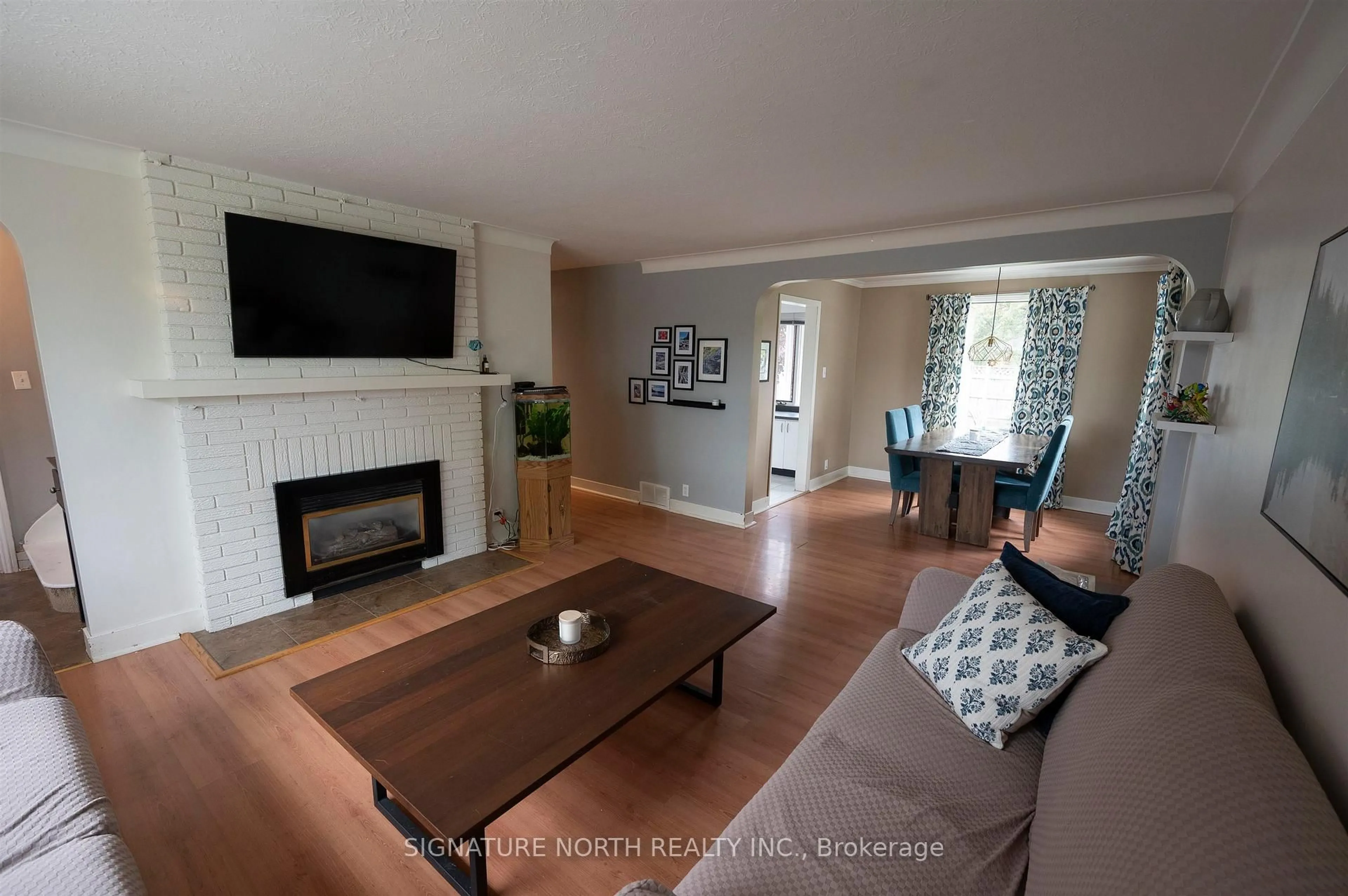Living room with furniture, wood/laminate floor for 2018 Donald Street East, Thunder Bay Ontario P7E 5W8