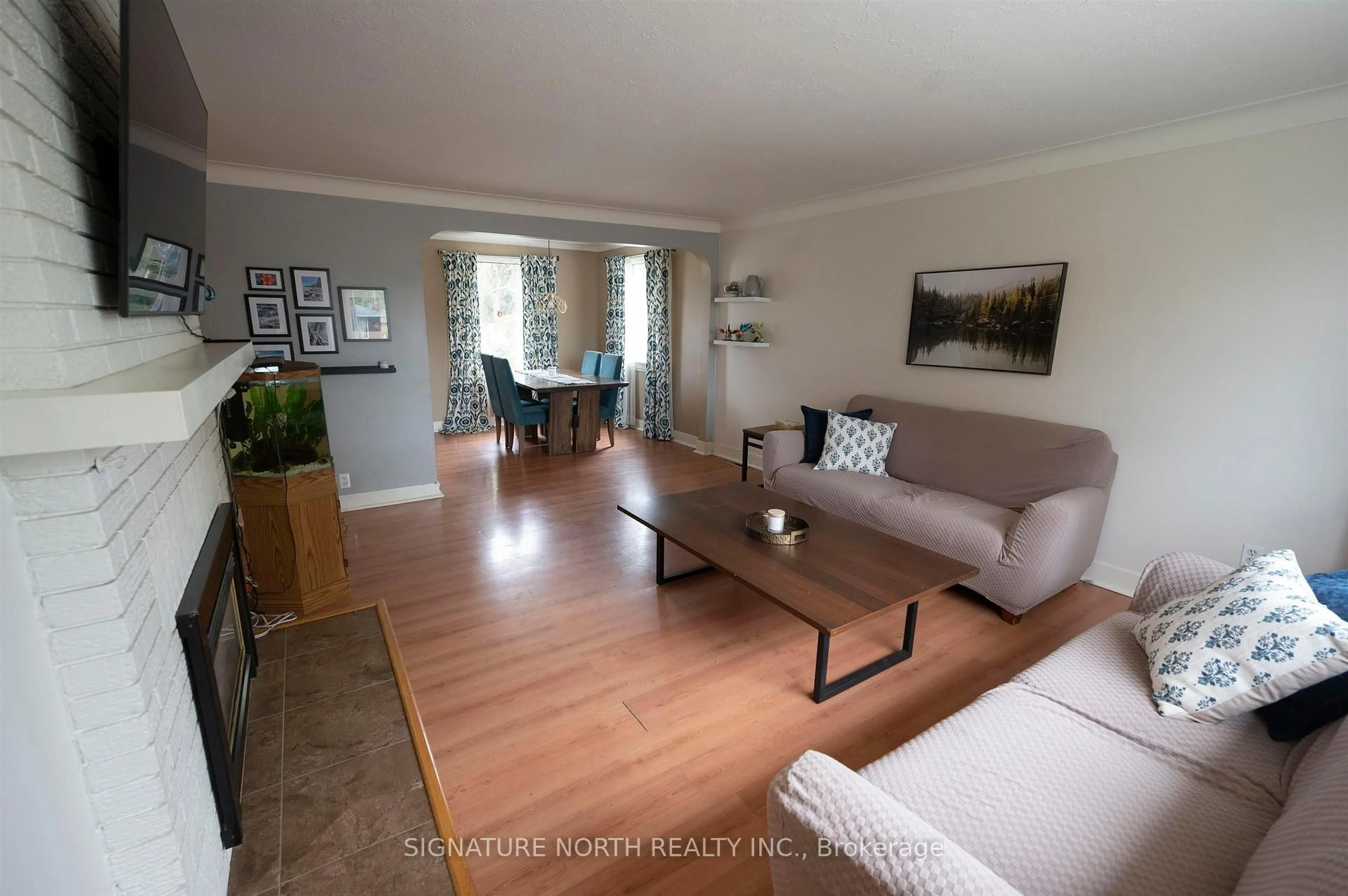 Living room with furniture, wood/laminate floor for 2018 Donald Street East, Thunder Bay Ontario P7E 5W8