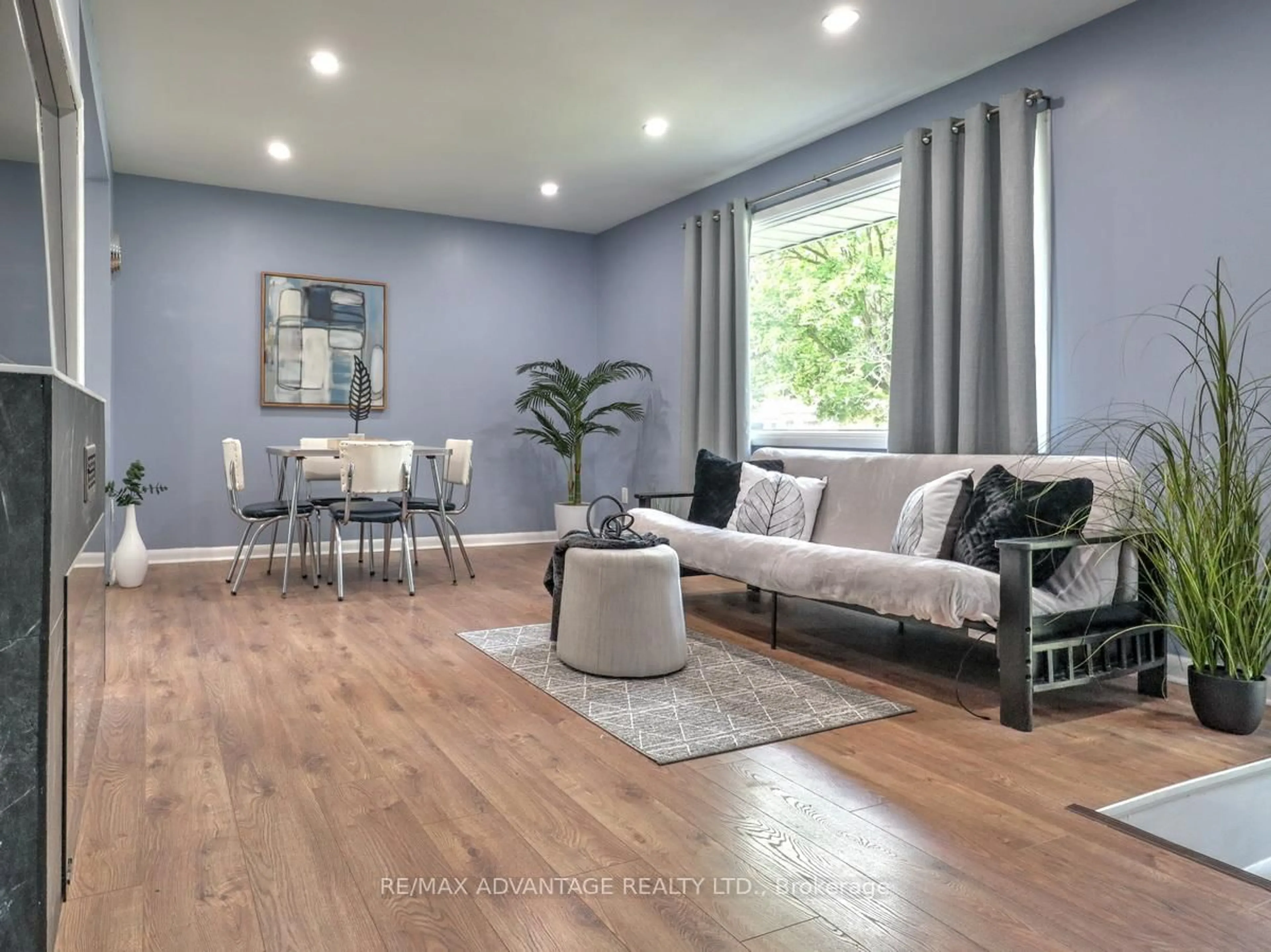 Living room with furniture, wood/laminate floor for 63 Pawnee Cres, London East Ontario N5V 2T2