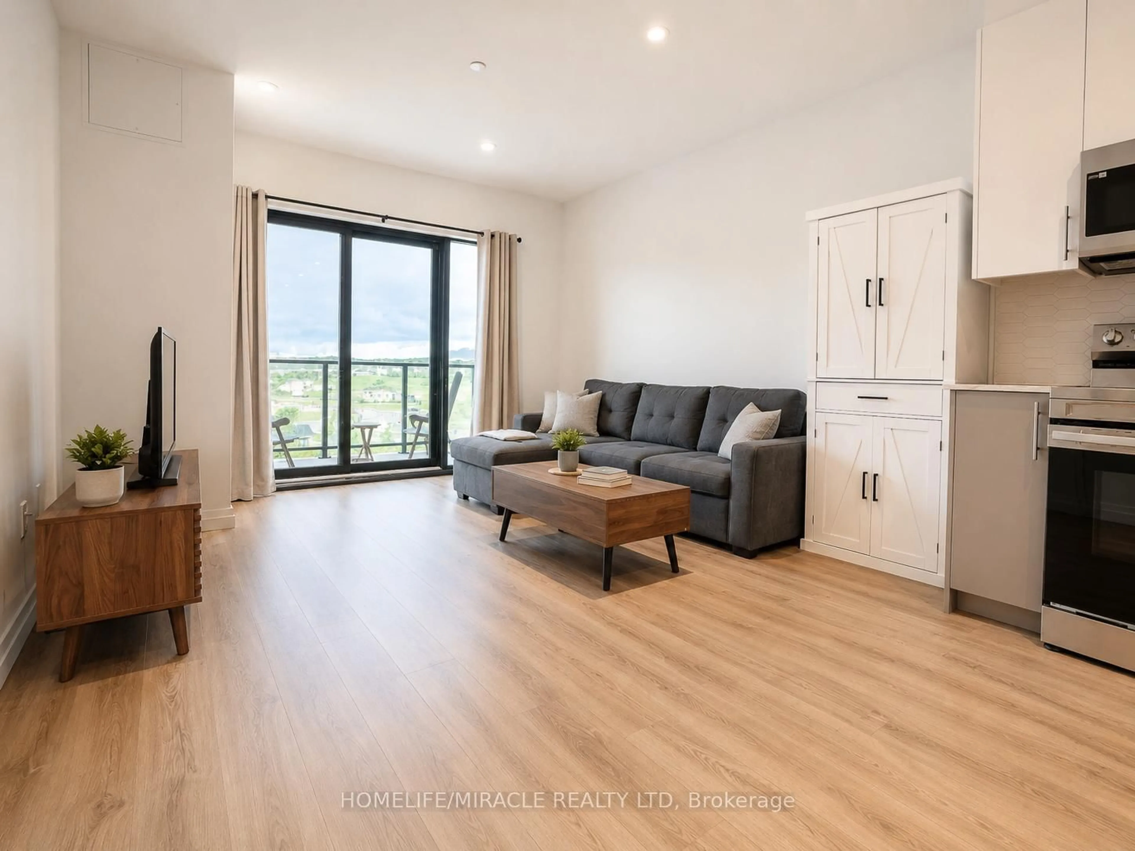 Living room with furniture, wood/laminate floor for 525 New Dundee Rd #516, Kitchener Ontario N2P 0K8