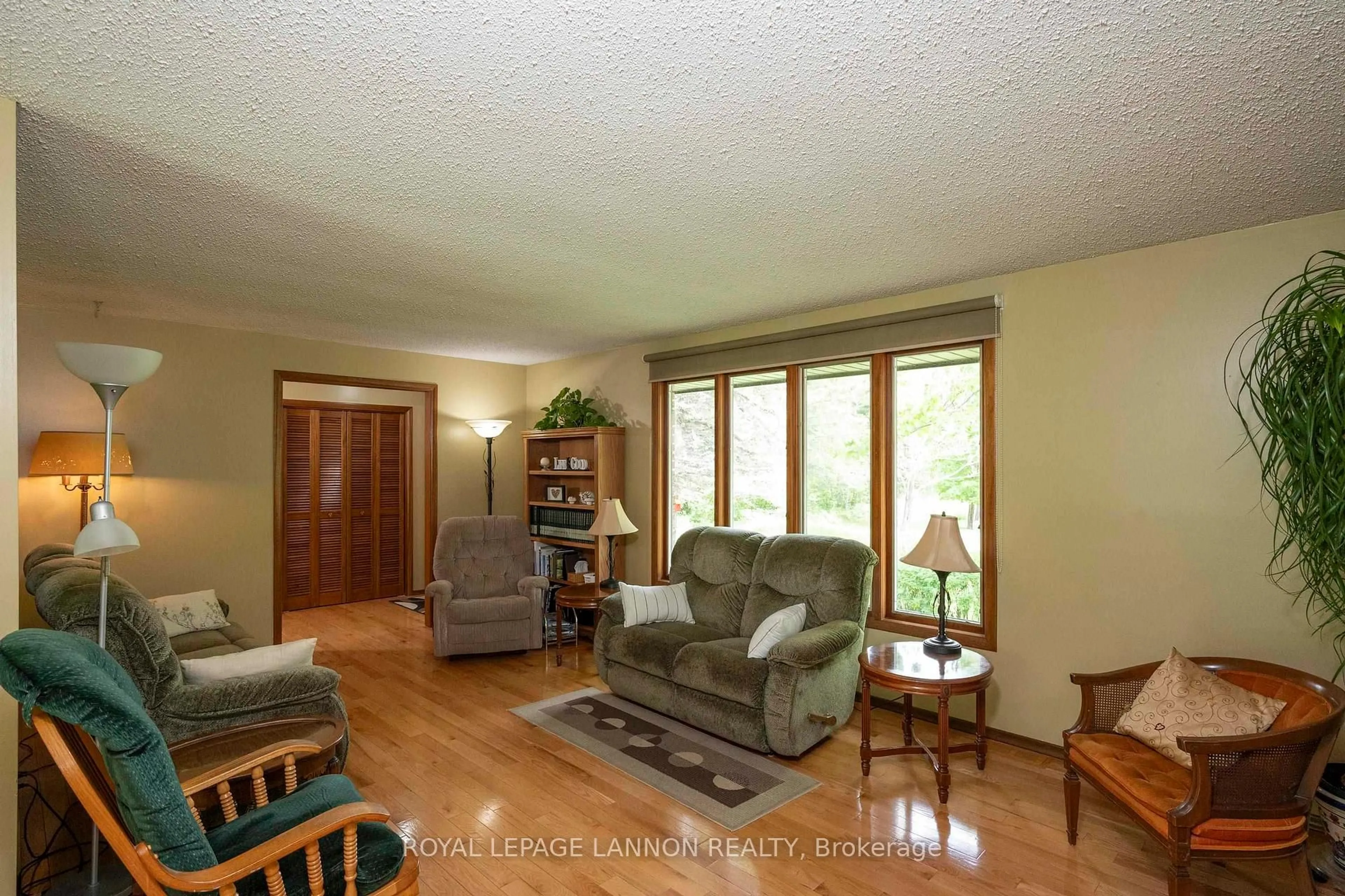 Living room with furniture, wood/laminate floor for 691 Nicholetts Rd, Oliver Paipoonge Ontario P0T 2G0