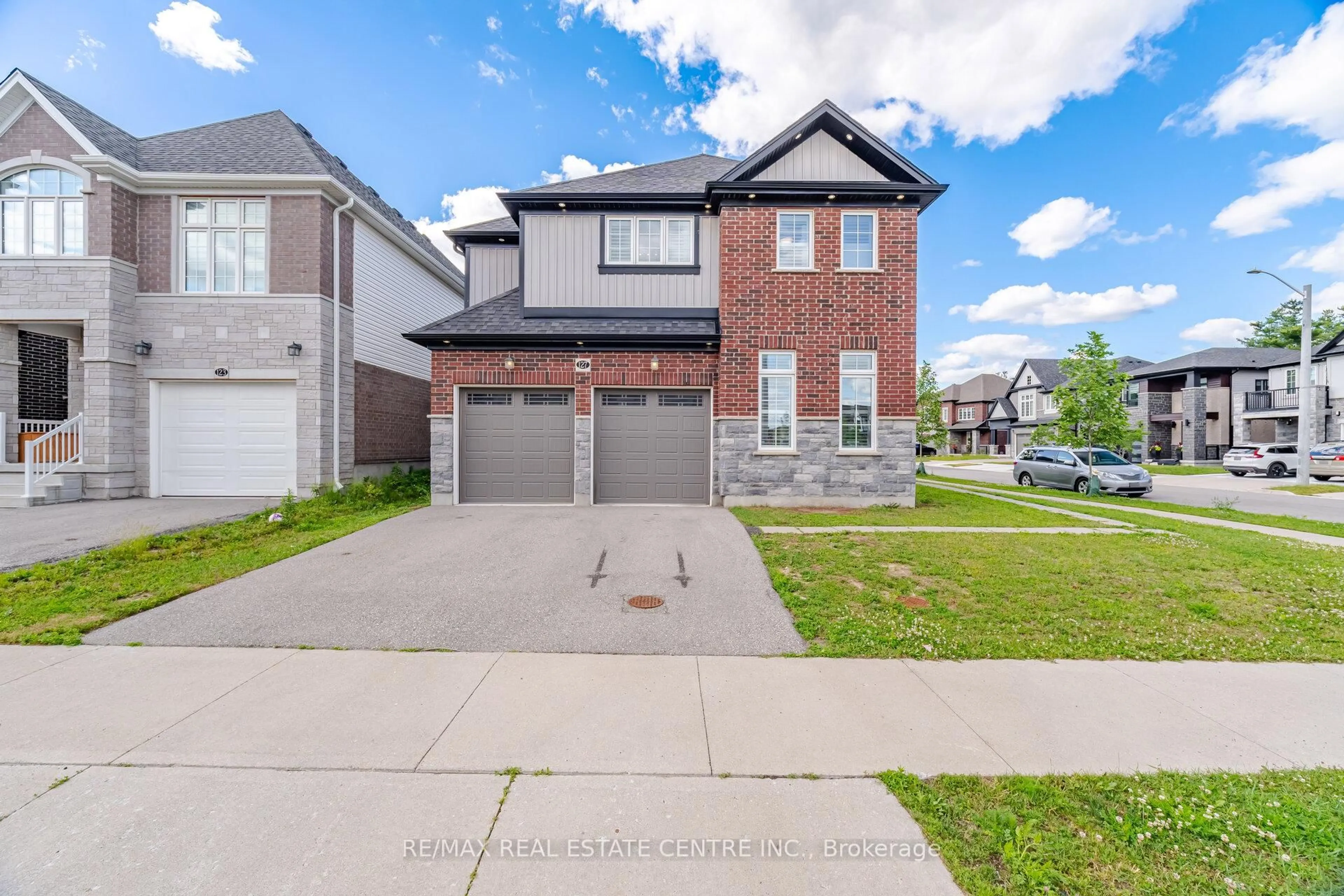 Home with brick exterior material, street for 127 Monarch Woods Dr, Kitchener Ontario N2P 2Y9