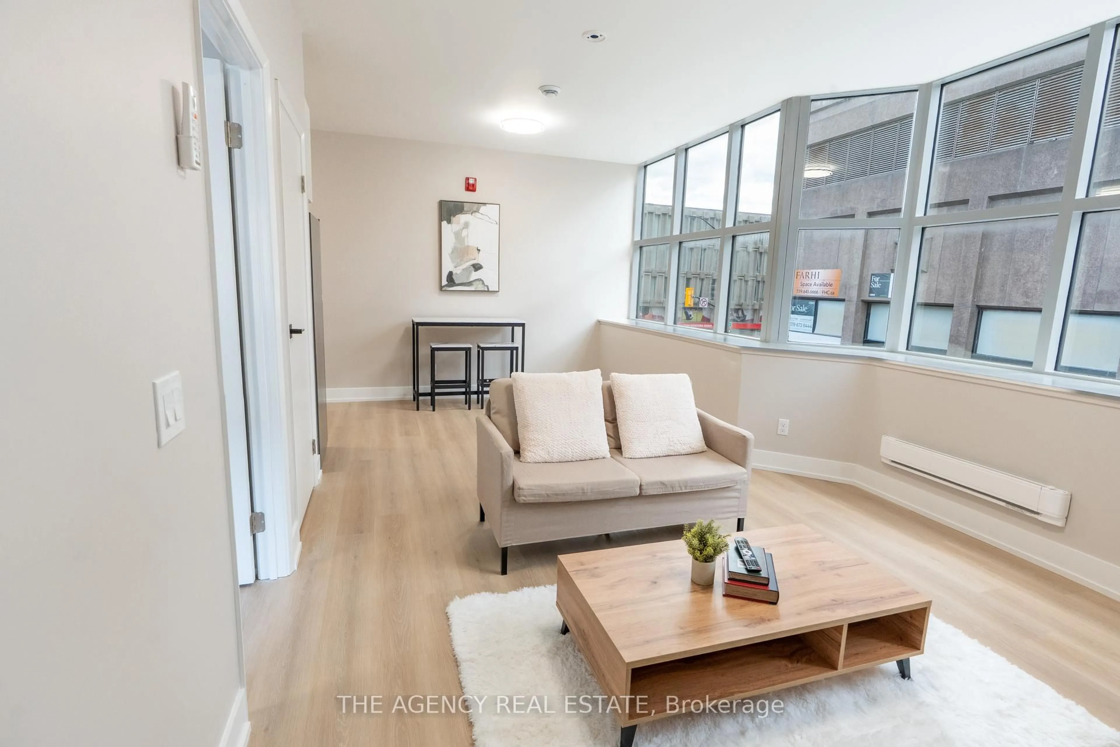 Living room with furniture, wood/laminate floor for 376 Richmond St, London East Ontario N6A 3C7