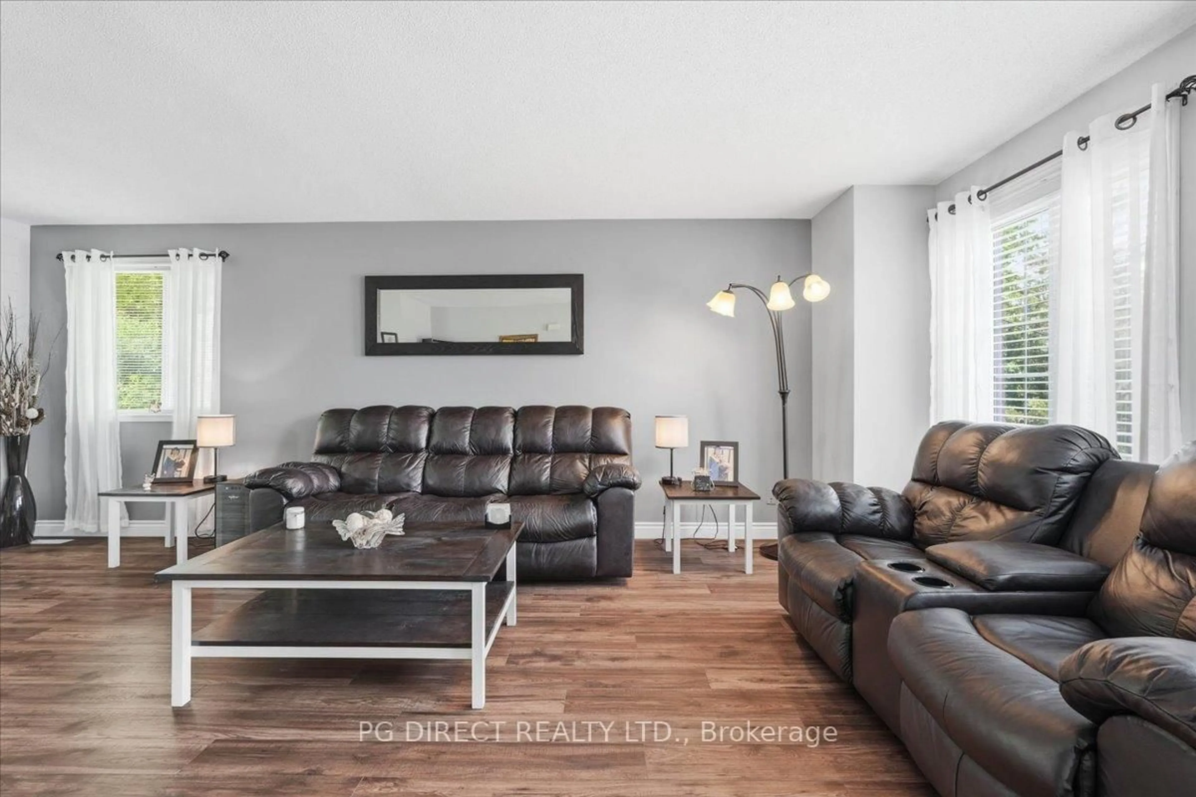Living room with furniture, wood/laminate floor for 24 Wooler Rd, Quinte West Ontario K8V 4J5