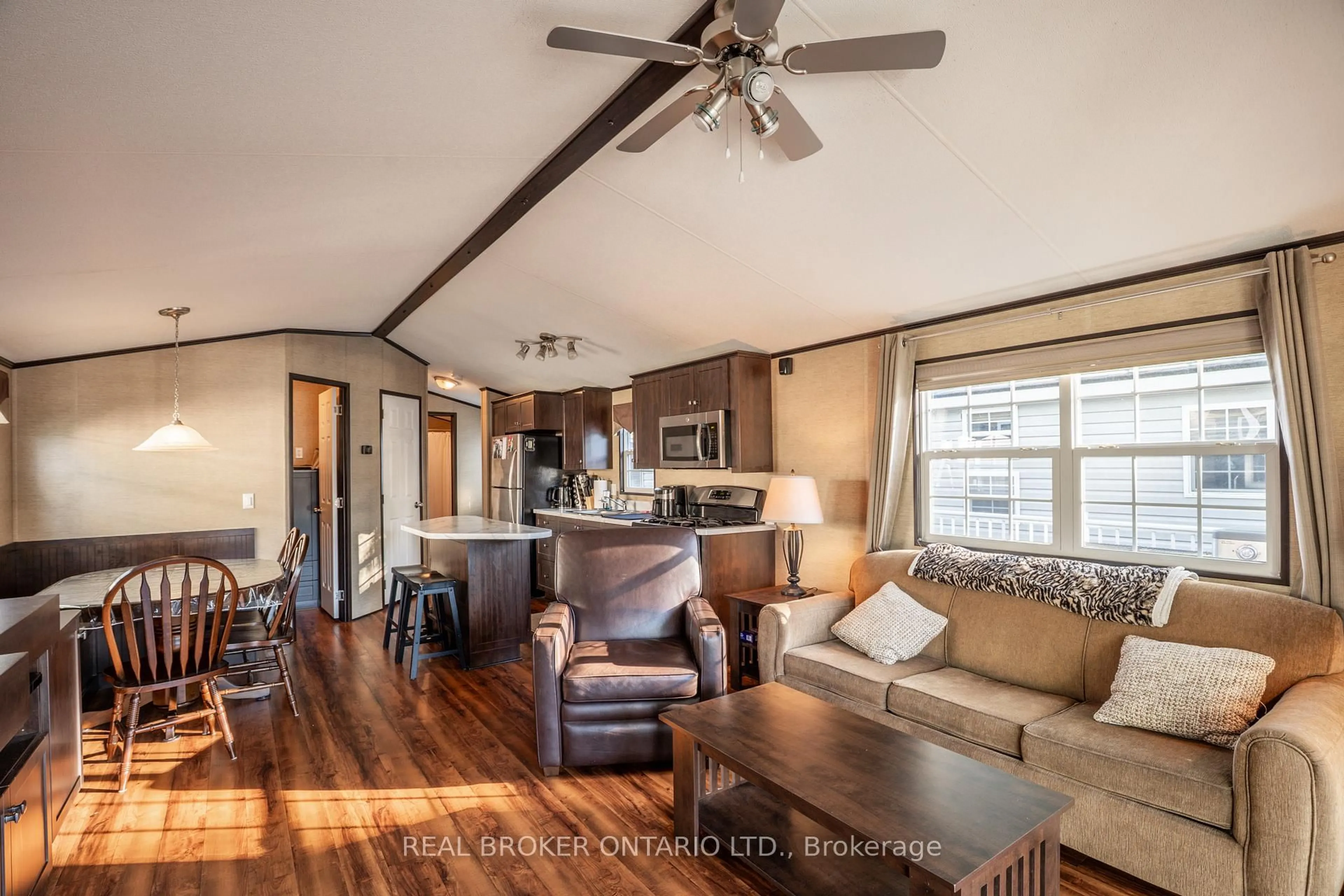 Living room with furniture, wood/laminate floor for 1082 Shamrock Marina Rd #16, Gravenhurst Ontario P0E 1N0