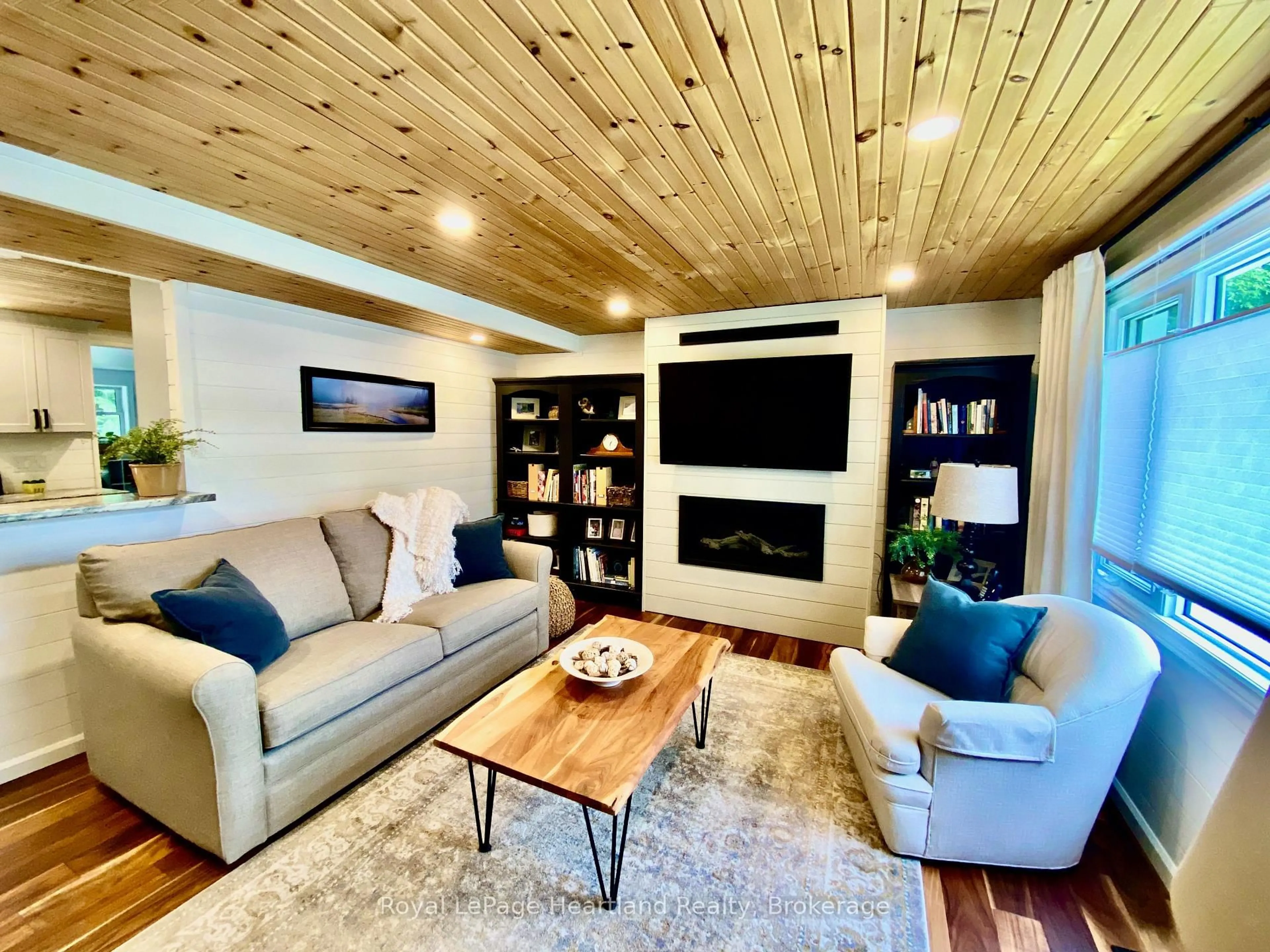 Living room with furniture, wood/laminate floor for 206 Chestnut Dr, Central Huron Ontario N0M 1G0