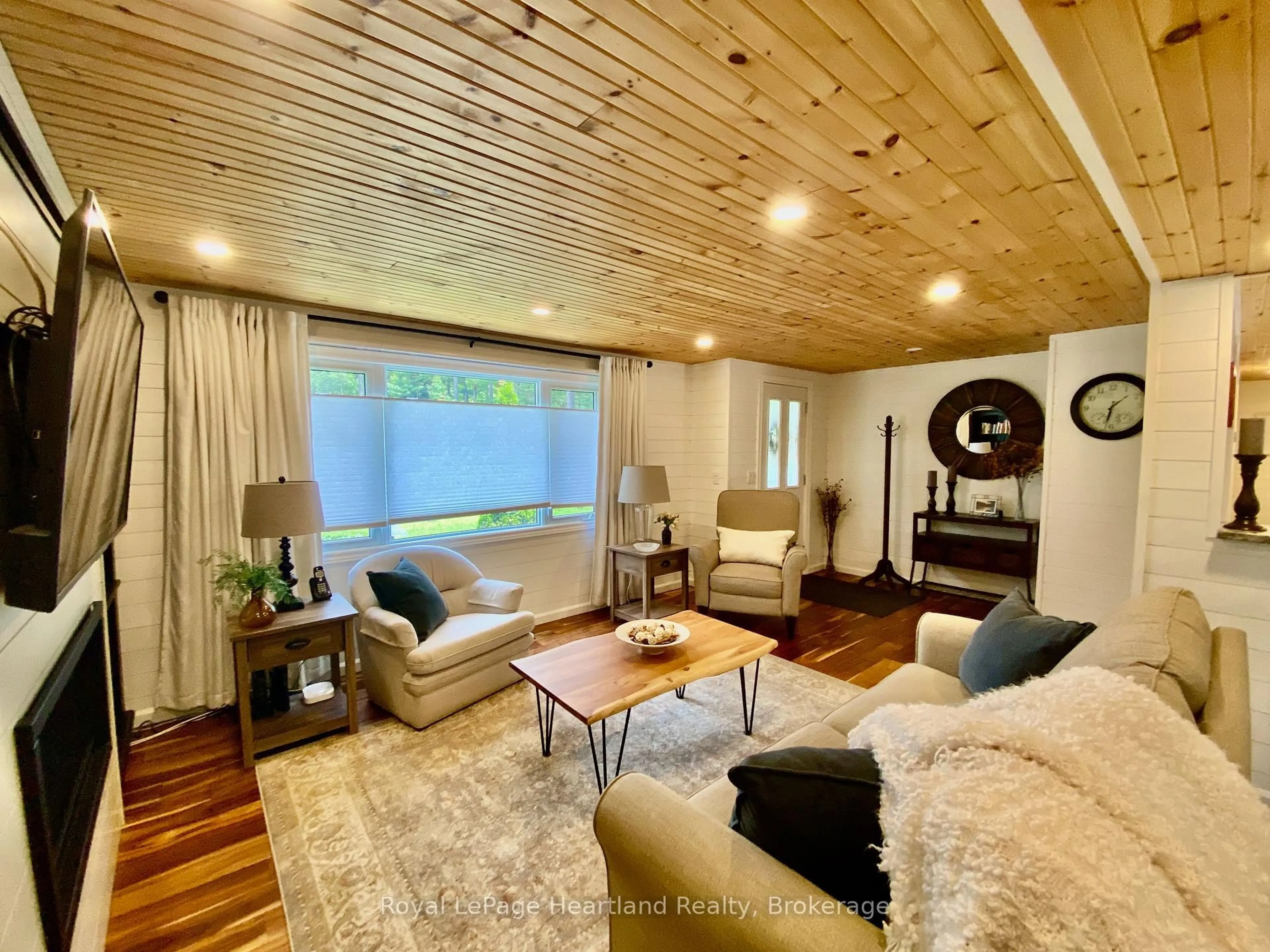 Living room with furniture, wood/laminate floor for 206 Chestnut Dr, Central Huron Ontario N0M 1G0