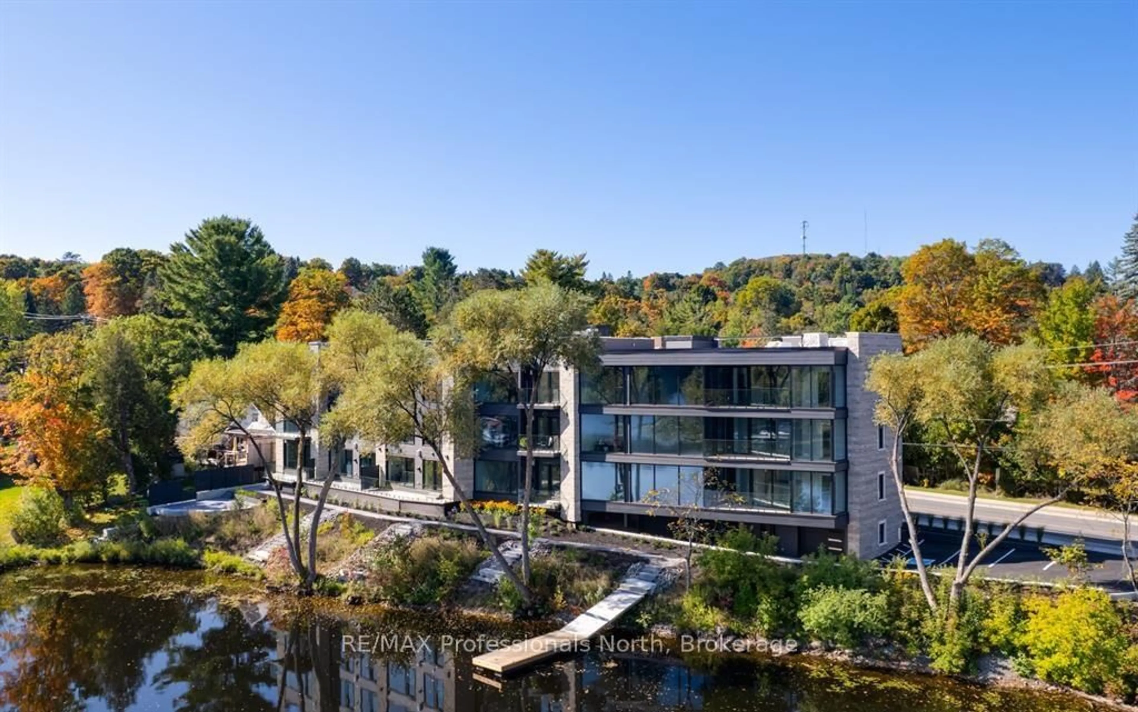 A pic from outside/outdoor area/front of a property/back of a property/a pic from drone, water/lake/river/ocean view for 32 BRUNEL Rd #205, Huntsville Ontario P1H 1P5