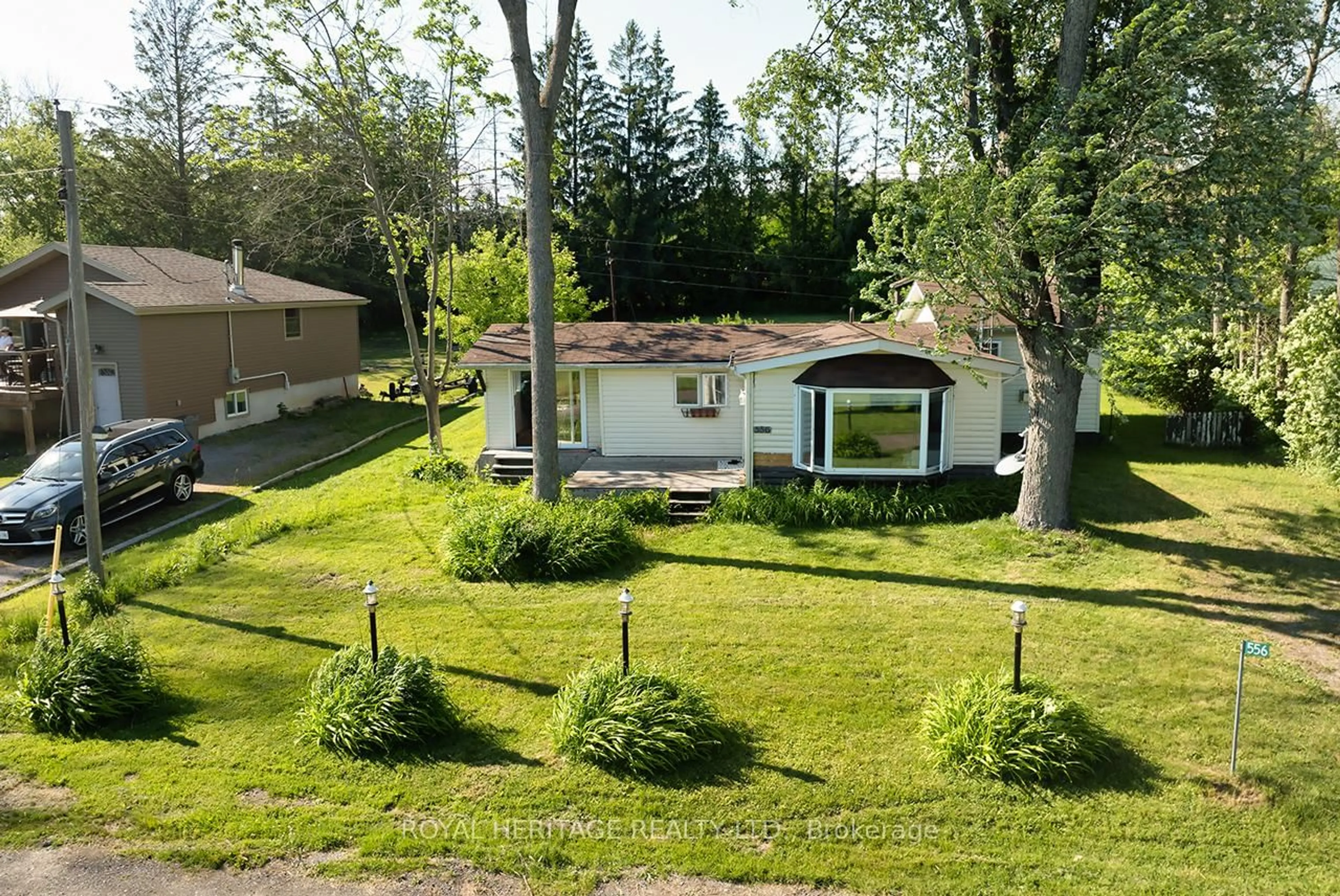 A pic from outside/outdoor area/front of a property/back of a property/a pic from drone, street for 556 North Shore Dr, Otonabee-South Monaghan Ontario K0L 1B0