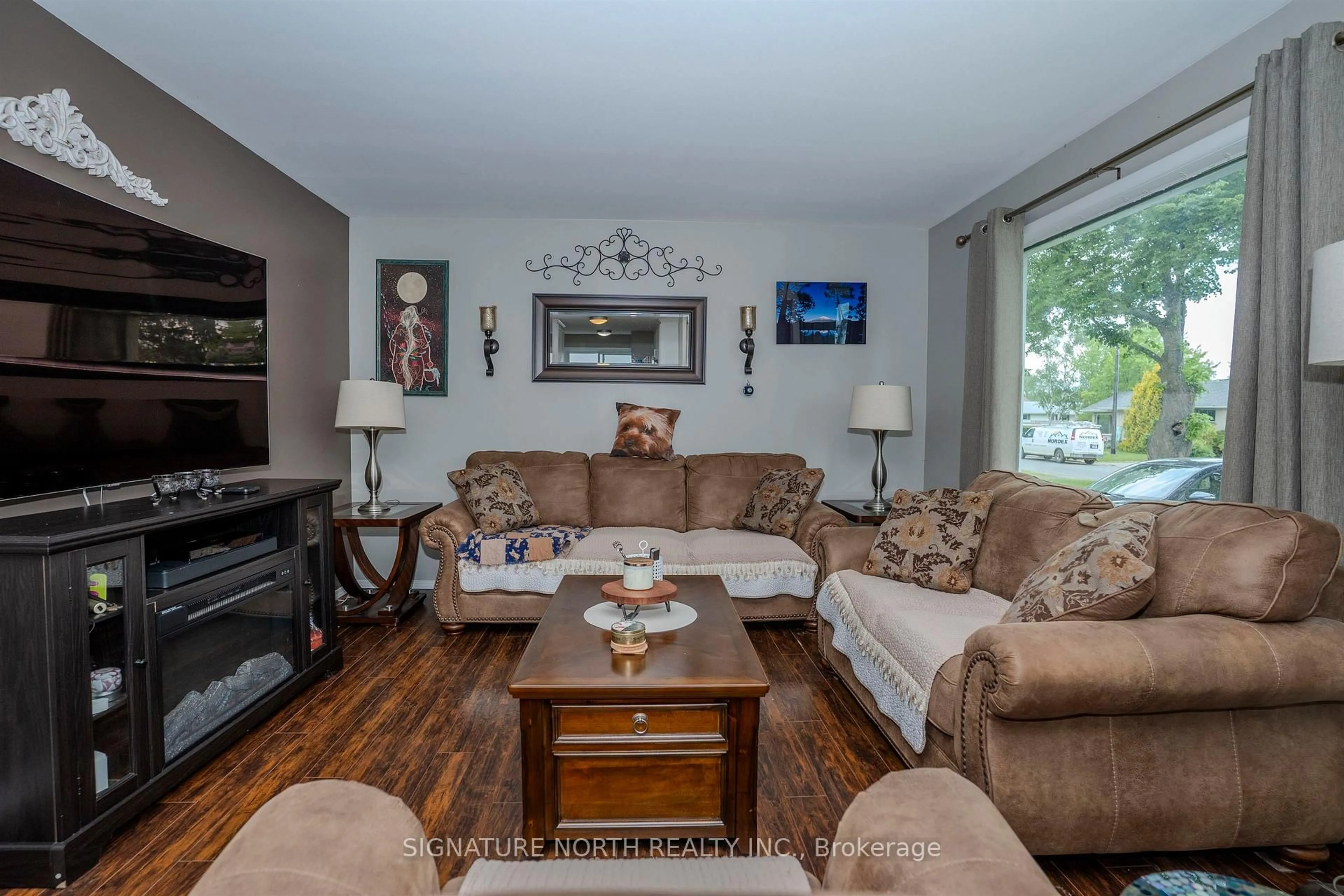 Living room with furniture, wood/laminate floor for 728 Linwood Cres, Thunder Bay Ontario P7E 2S1