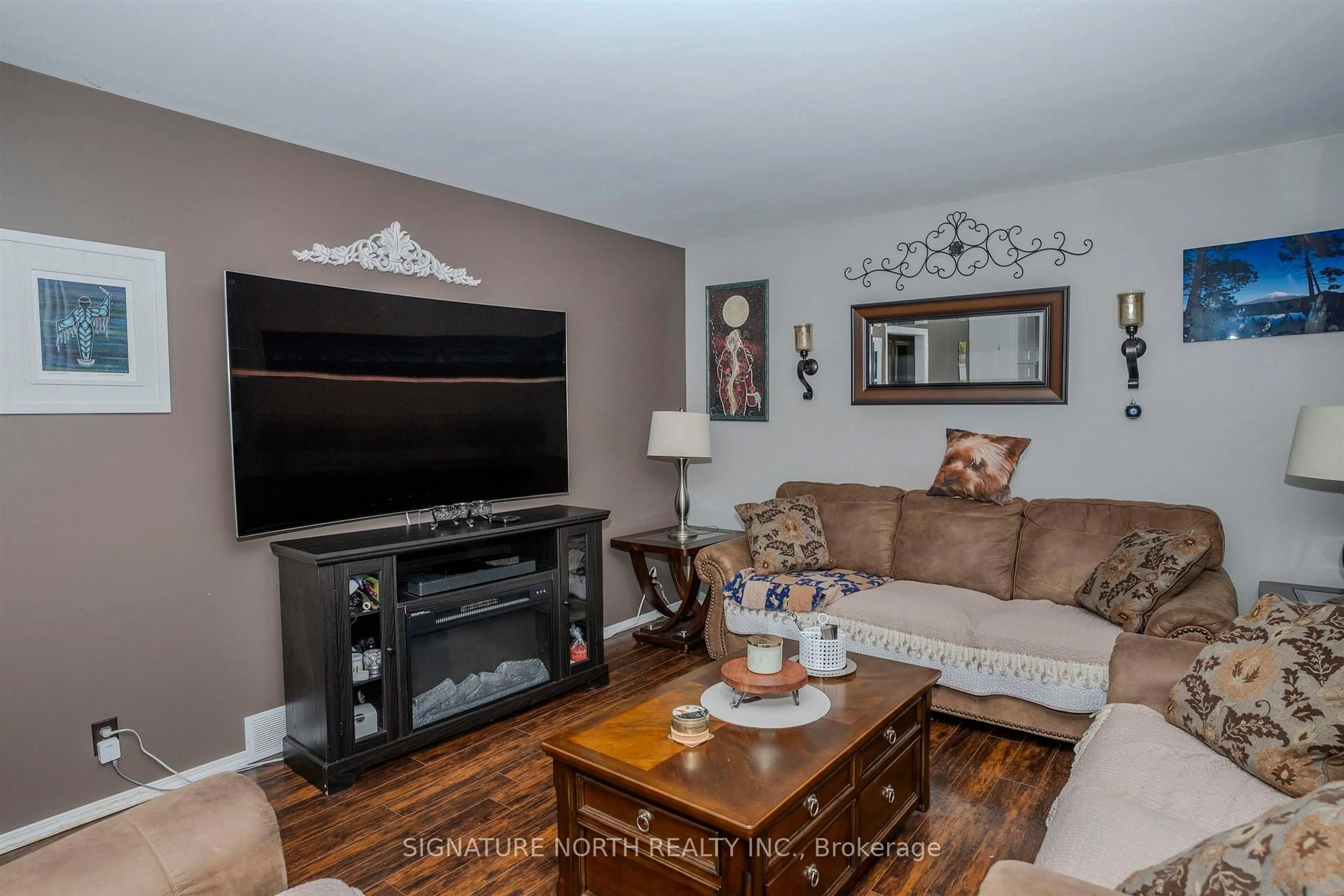 Living room with furniture, wood/laminate floor for 728 Linwood Cres, Thunder Bay Ontario P7E 2S1