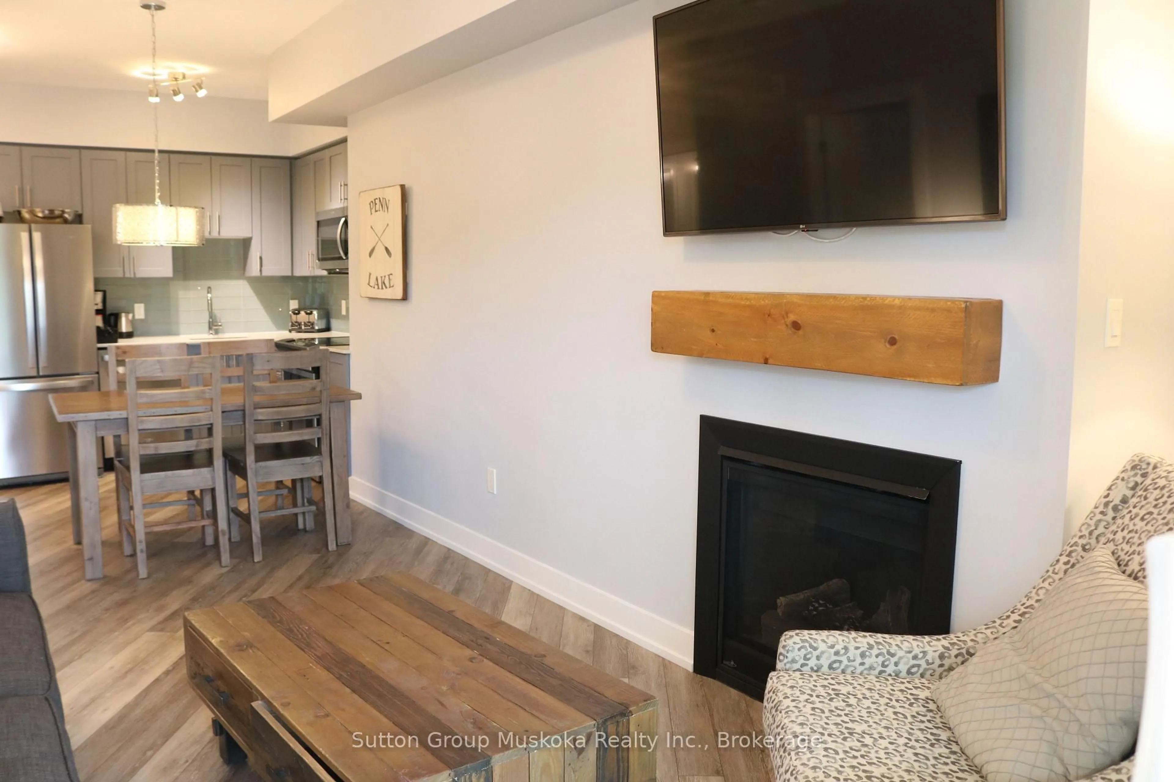 Living room with furniture, wood/laminate floor for 25 Pen Lake Point Rd #208, Huntsville Ontario P1H 1A9