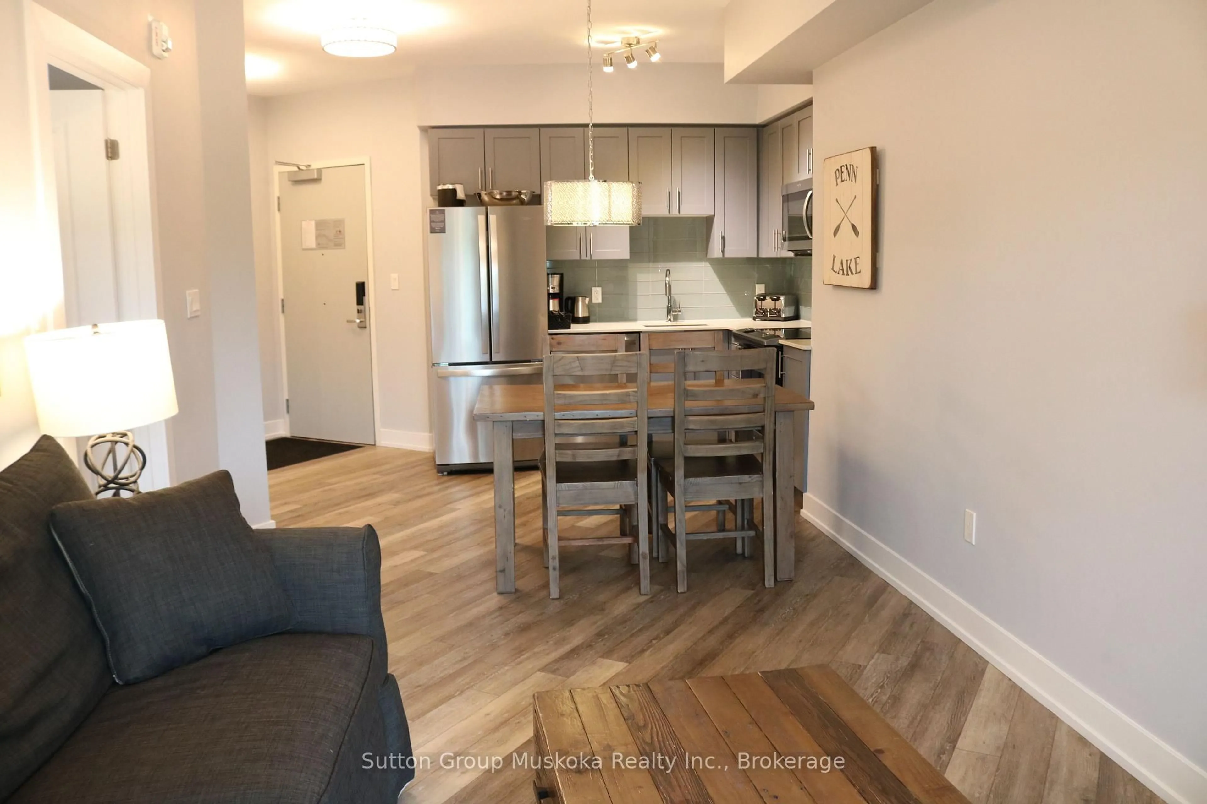 Open concept kitchen, wood/laminate floor for 25 Pen Lake Point Rd #208, Huntsville Ontario P1H 1A9