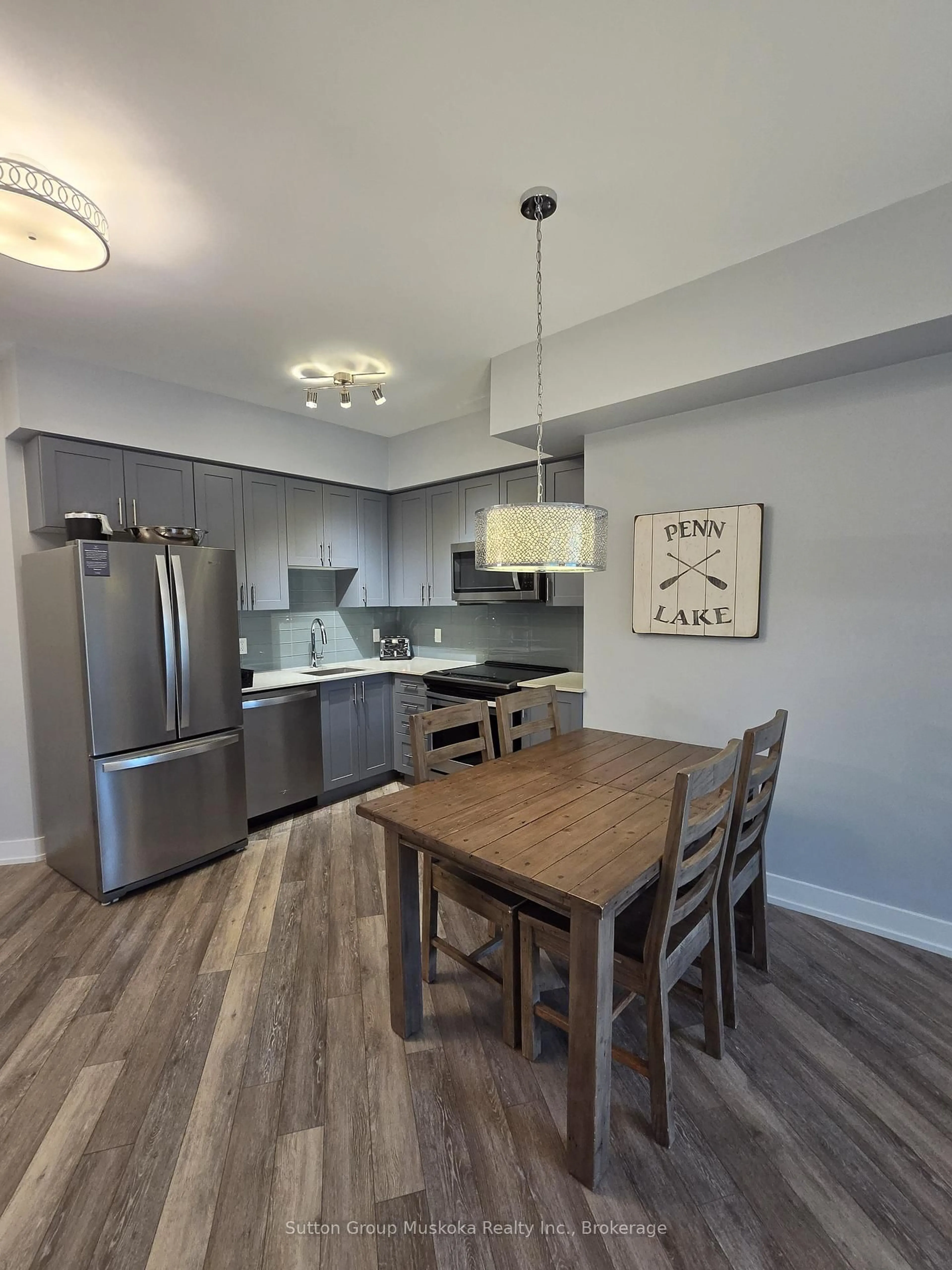 Open concept kitchen, wood/laminate floor for 25 Pen Lake Point Rd #208, Huntsville Ontario P1H 1A9