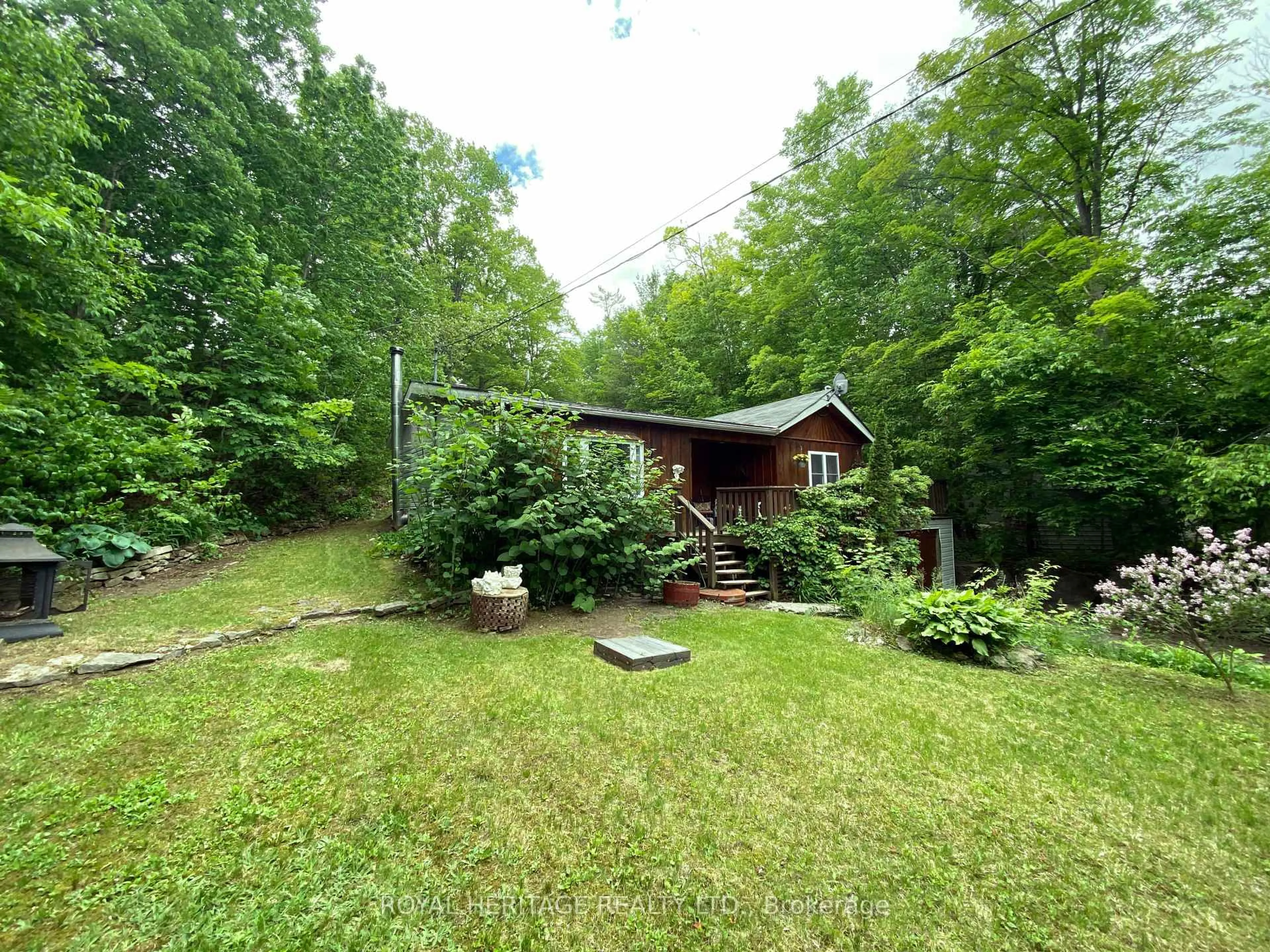 A pic from outside/outdoor area/front of a property/back of a property/a pic from drone, forest/trees view for 95 Whispering Waters Rd, Trent Hills Ontario K0K 2M0