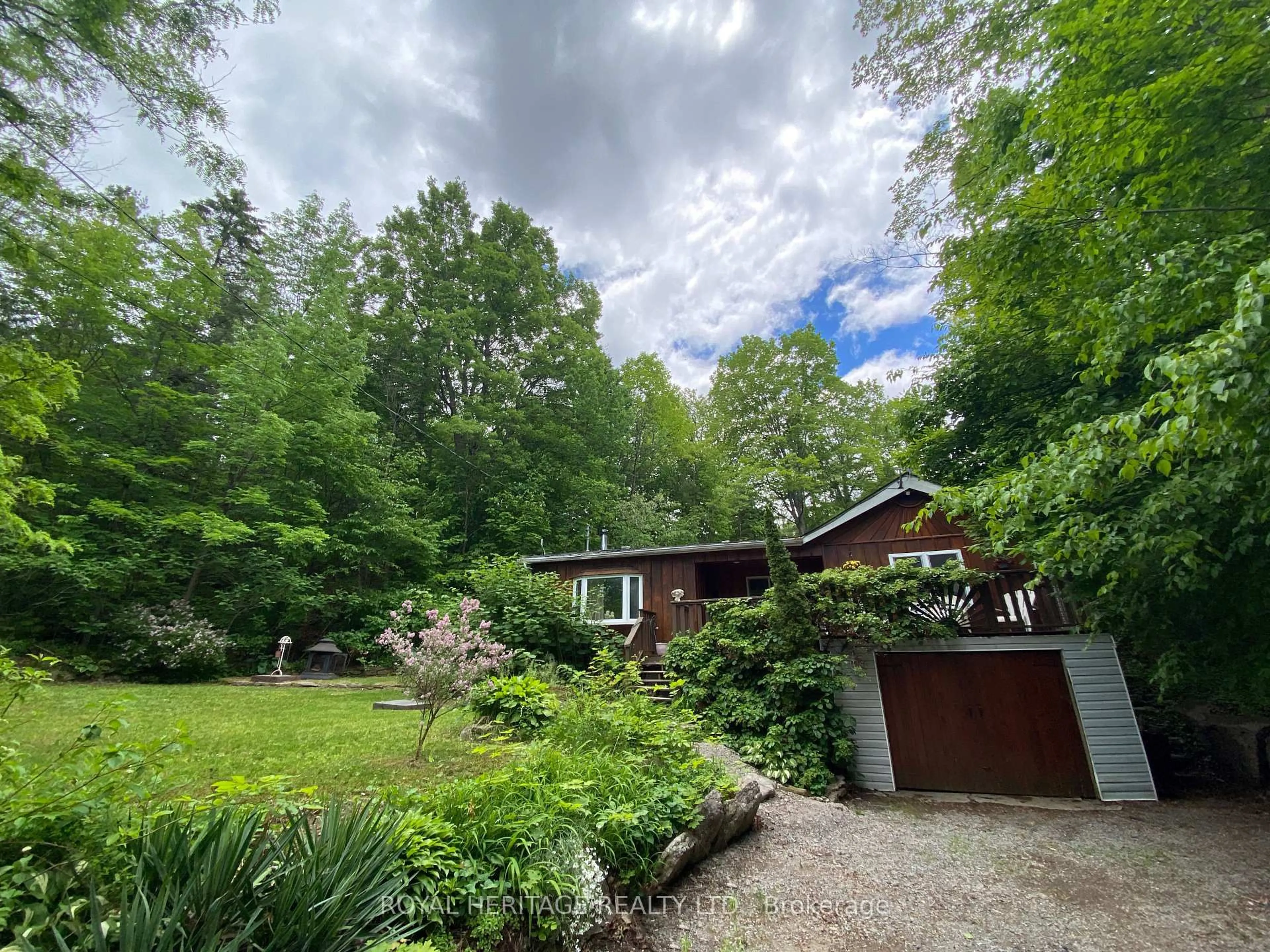 A pic from outside/outdoor area/front of a property/back of a property/a pic from drone, forest/trees view for 95 Whispering Waters Rd, Trent Hills Ontario K0K 2M0