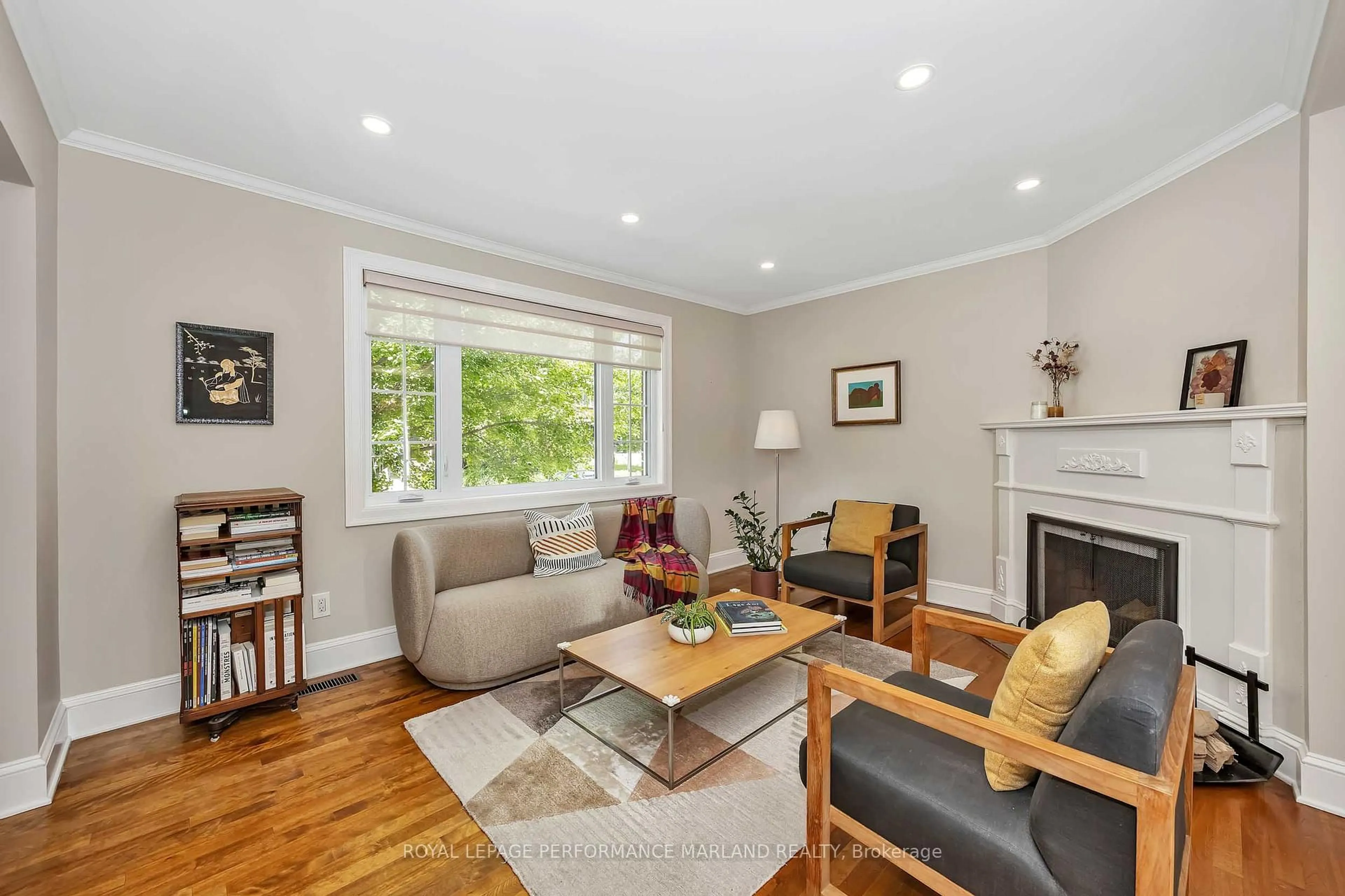 Living room with furniture, wood/laminate floor for 128 Mason Terr, Ottawa Ontario K1S 0L3