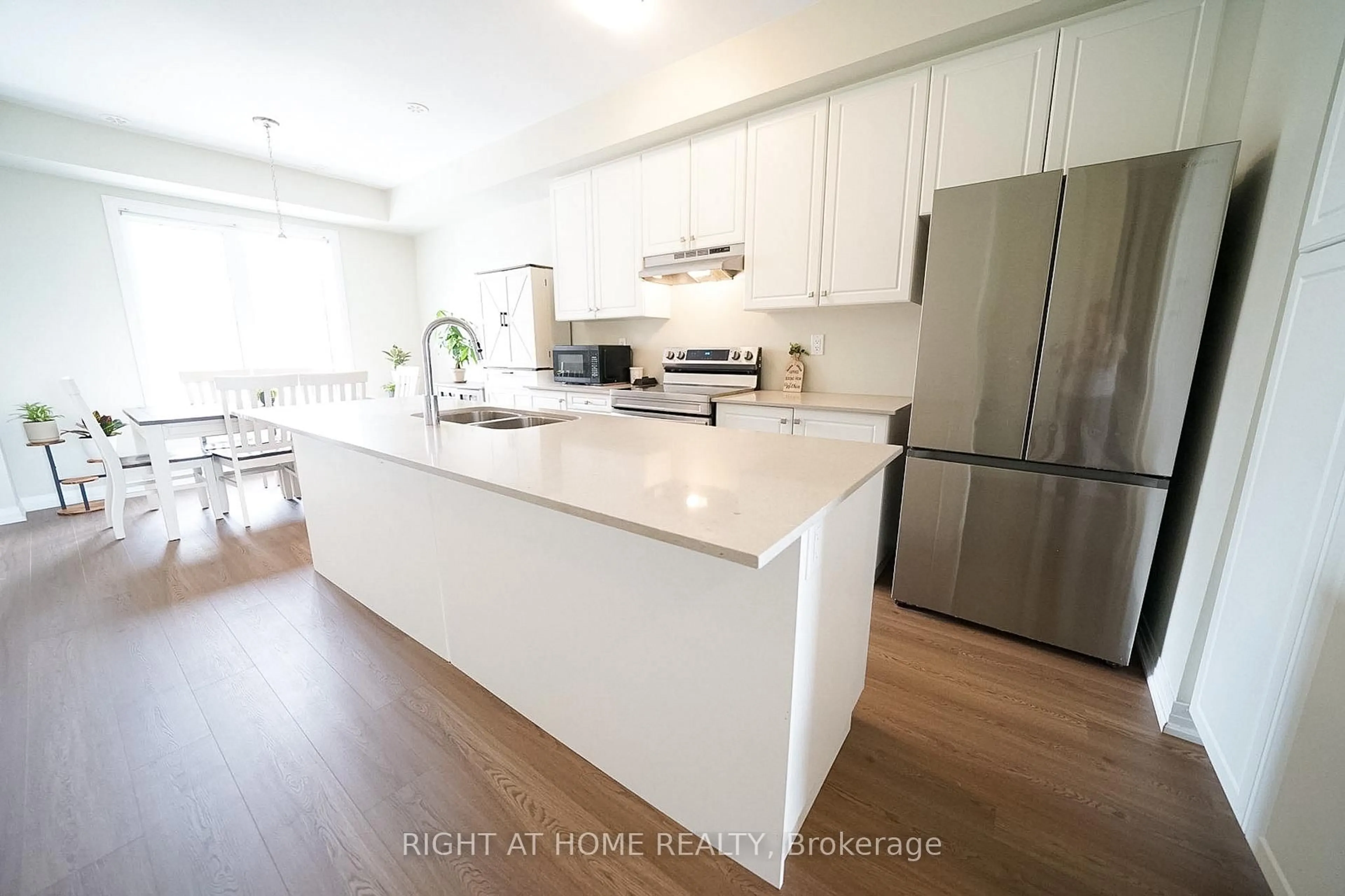 Open concept kitchen, wood/laminate floor for 185 Bedrock Dr #23, Hamilton Ontario L8J 0M5