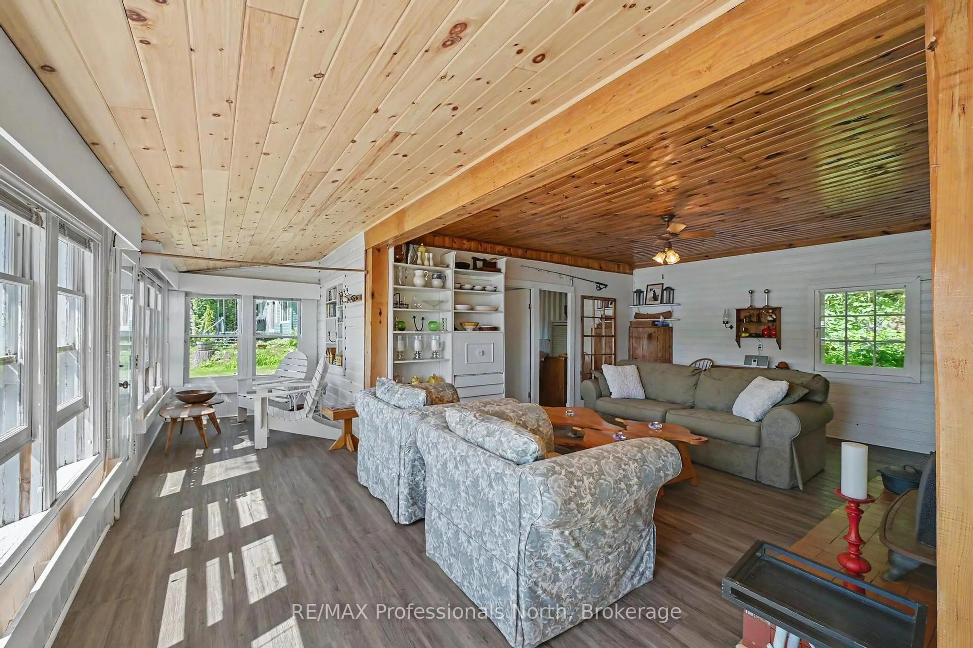 Living room with furniture, wood/laminate floor for 70 Fire Route 364A, Trent Lakes Ontario K0M 2A0