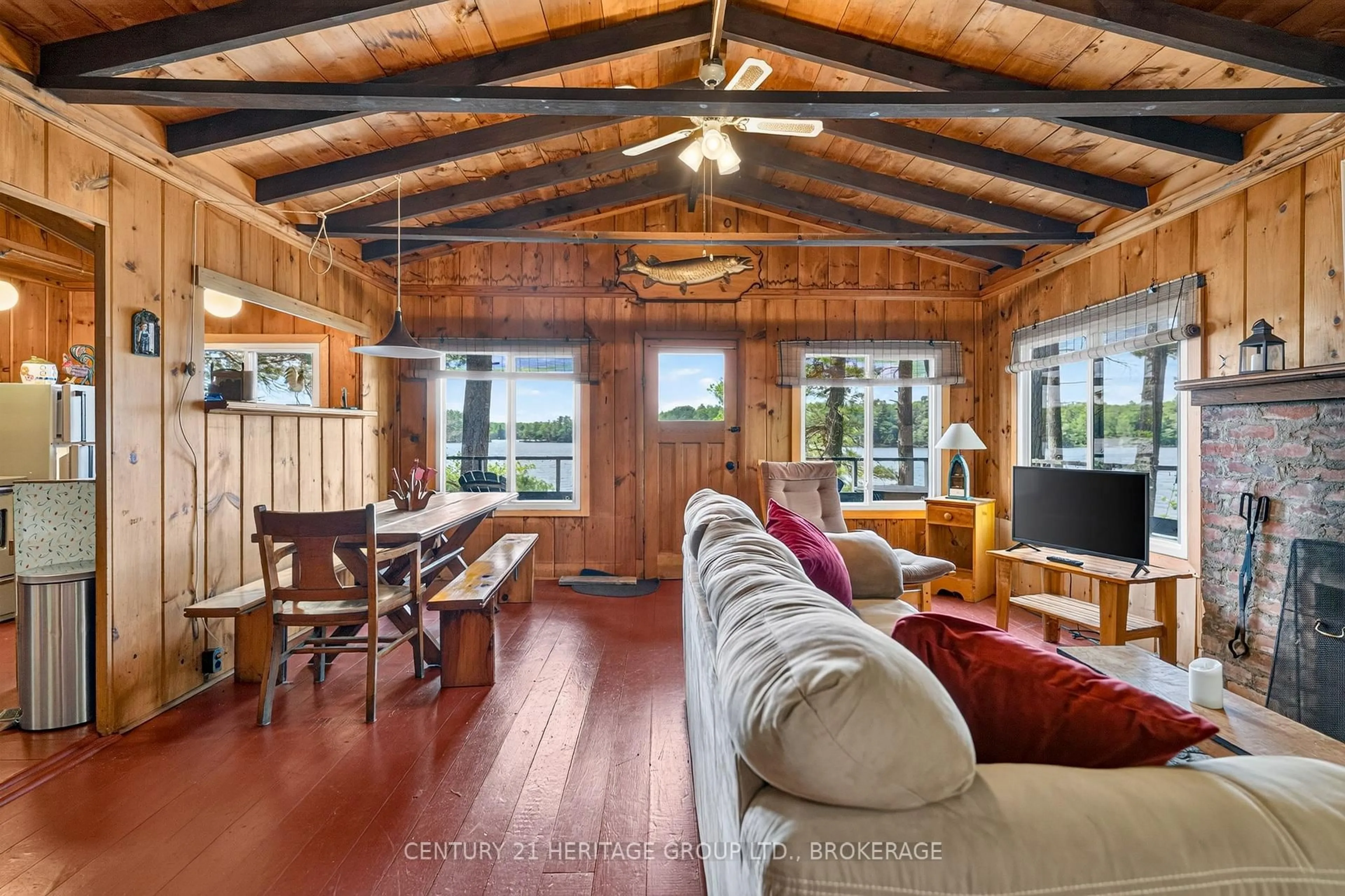 Living room with furniture, wood/laminate floor for 24853 Eagle Lake Rd, Tichborne Ontario K0H 2V0