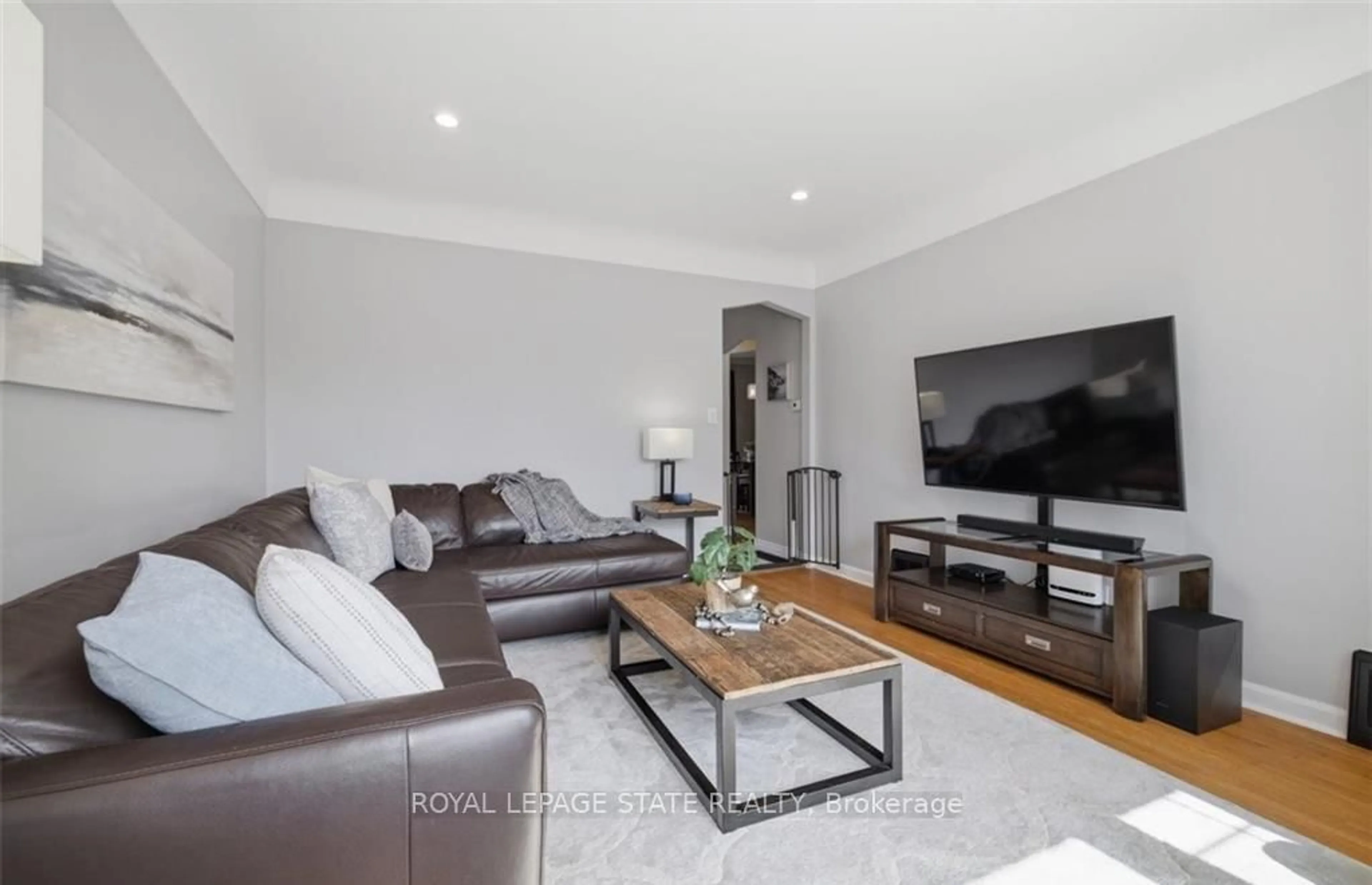 Living room with furniture, wood/laminate floor for 216 Summerhill Ave, Hamilton Ontario L8K 3N7