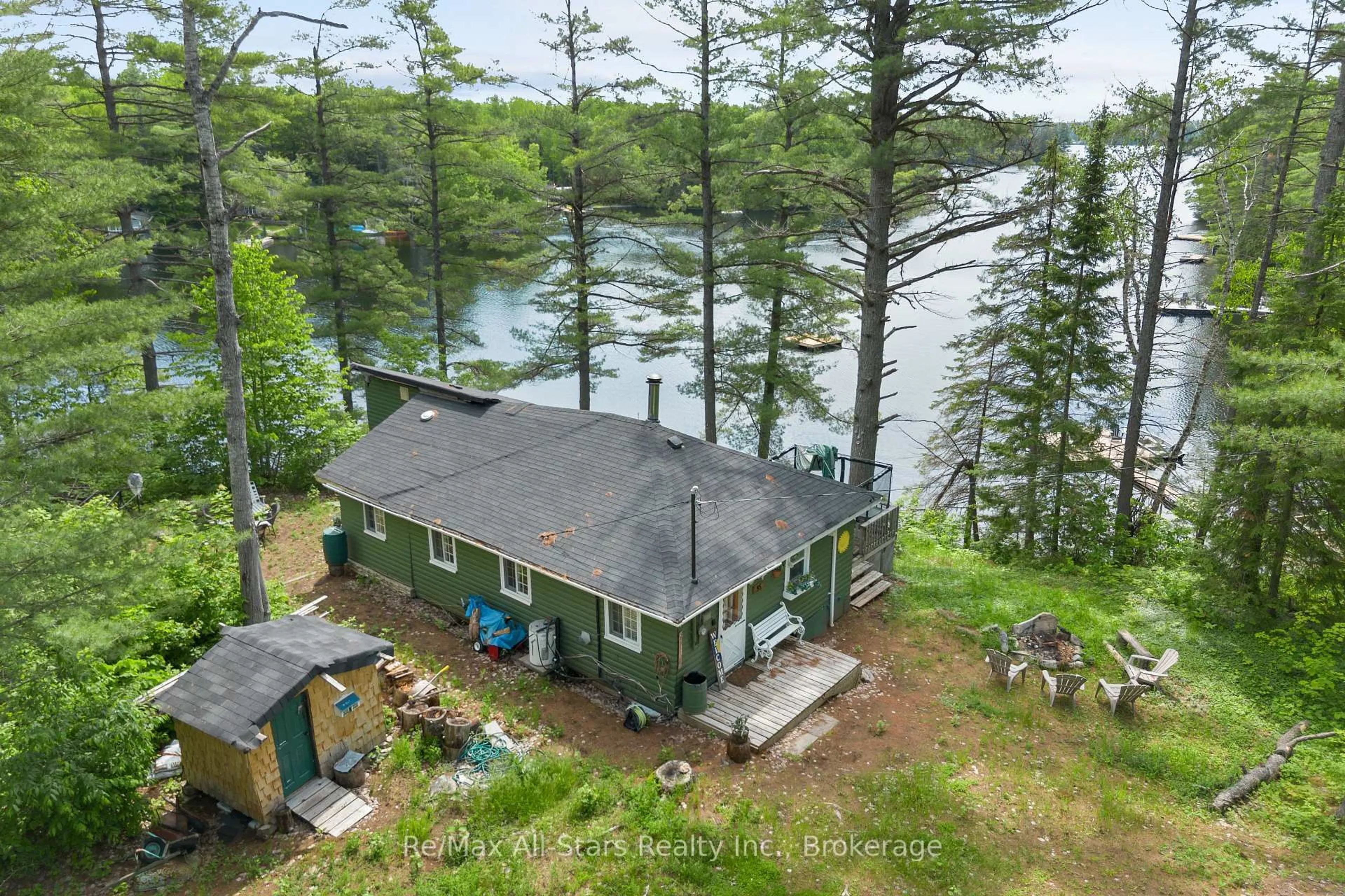 A pic from outside/outdoor area/front of a property/back of a property/a pic from drone, water/lake/river/ocean view for 95 West Clear Bay Pt, Trent Lakes Ontario K0M 2A0