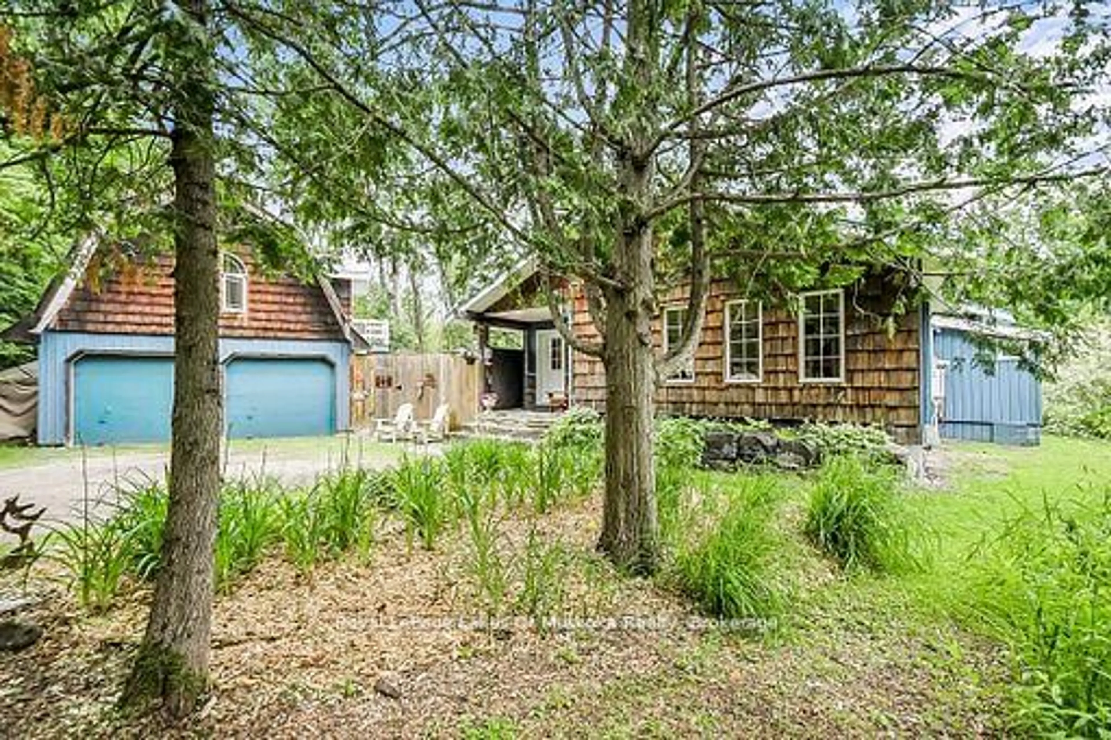 A pic from outside/outdoor area/front of a property/back of a property/a pic from drone, forest/trees view for 1005 Kirby's Beach Rd, Bracebridge Ontario P1L 1X2