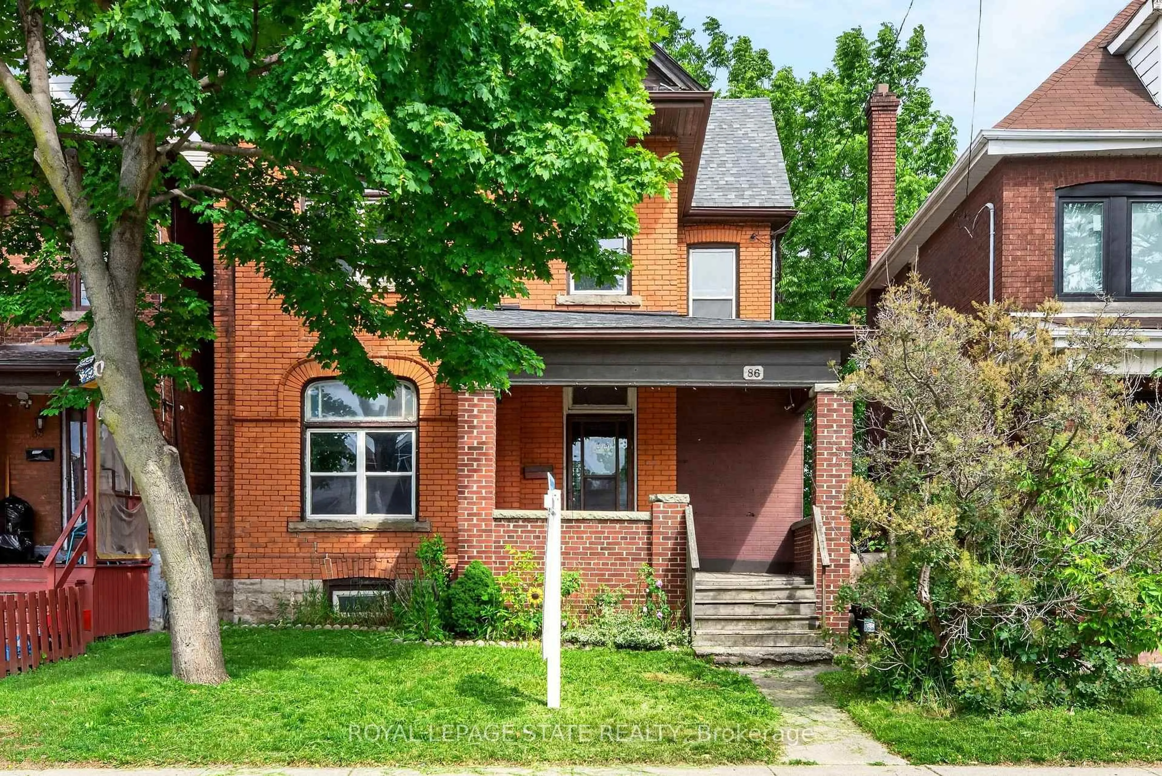 Home with brick exterior material, street for 86 Sherman Ave, Hamilton Ontario L8L 6M4