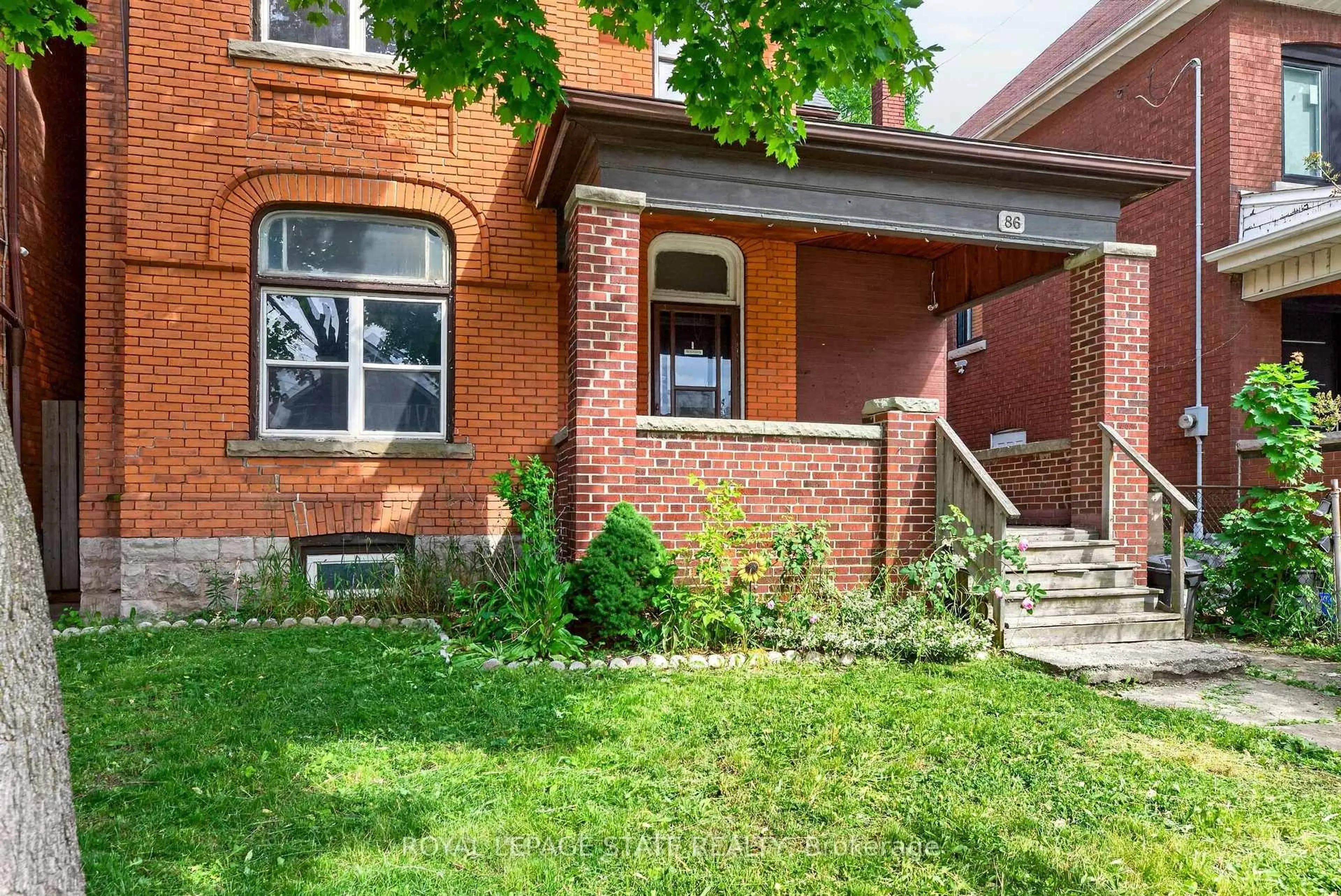 Home with brick exterior material, street for 86 Sherman Ave, Hamilton Ontario L8L 6M4