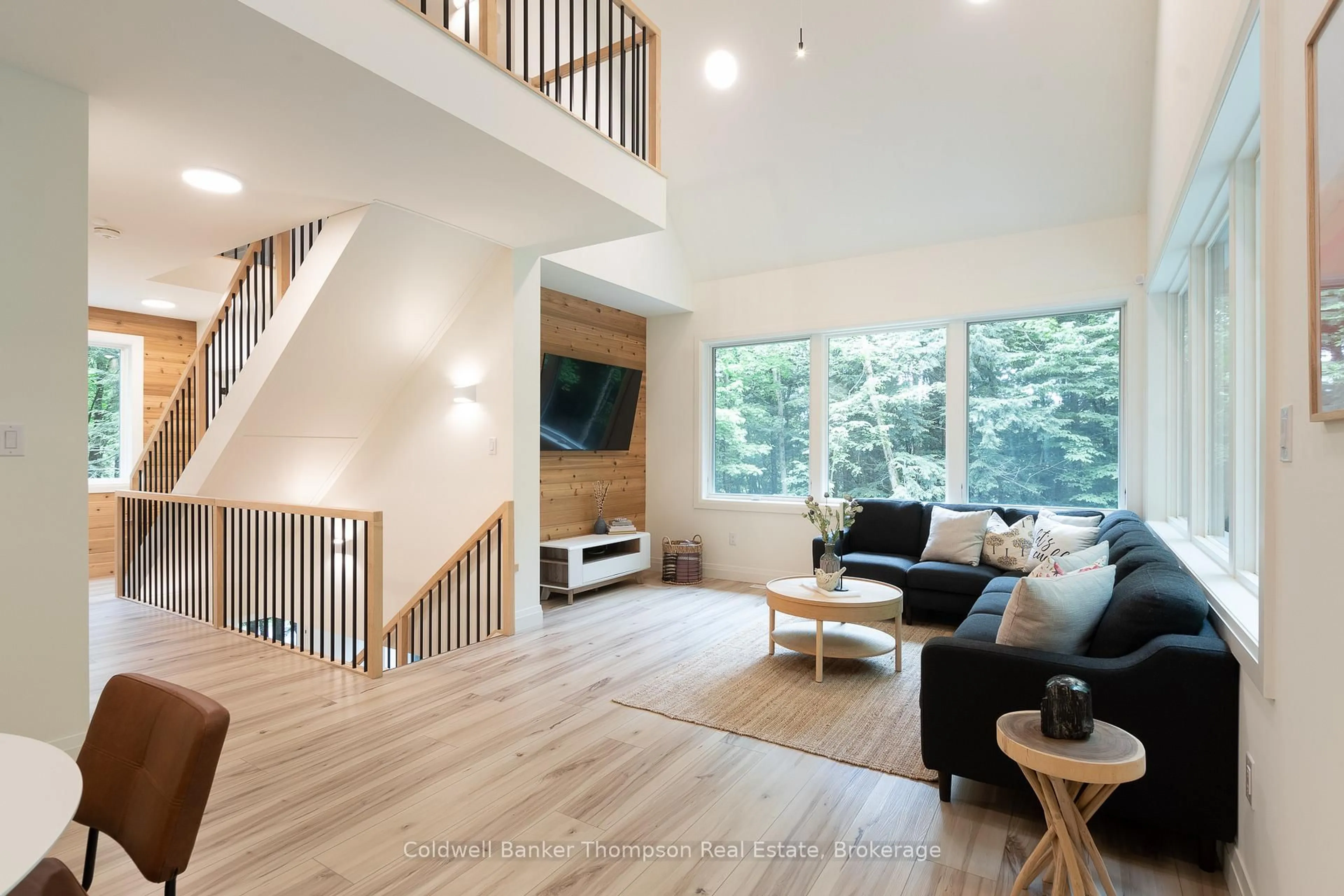 Living room with furniture, wood/laminate floor for 84 Vernon Lane, Huntsville Ontario P1H 2J2