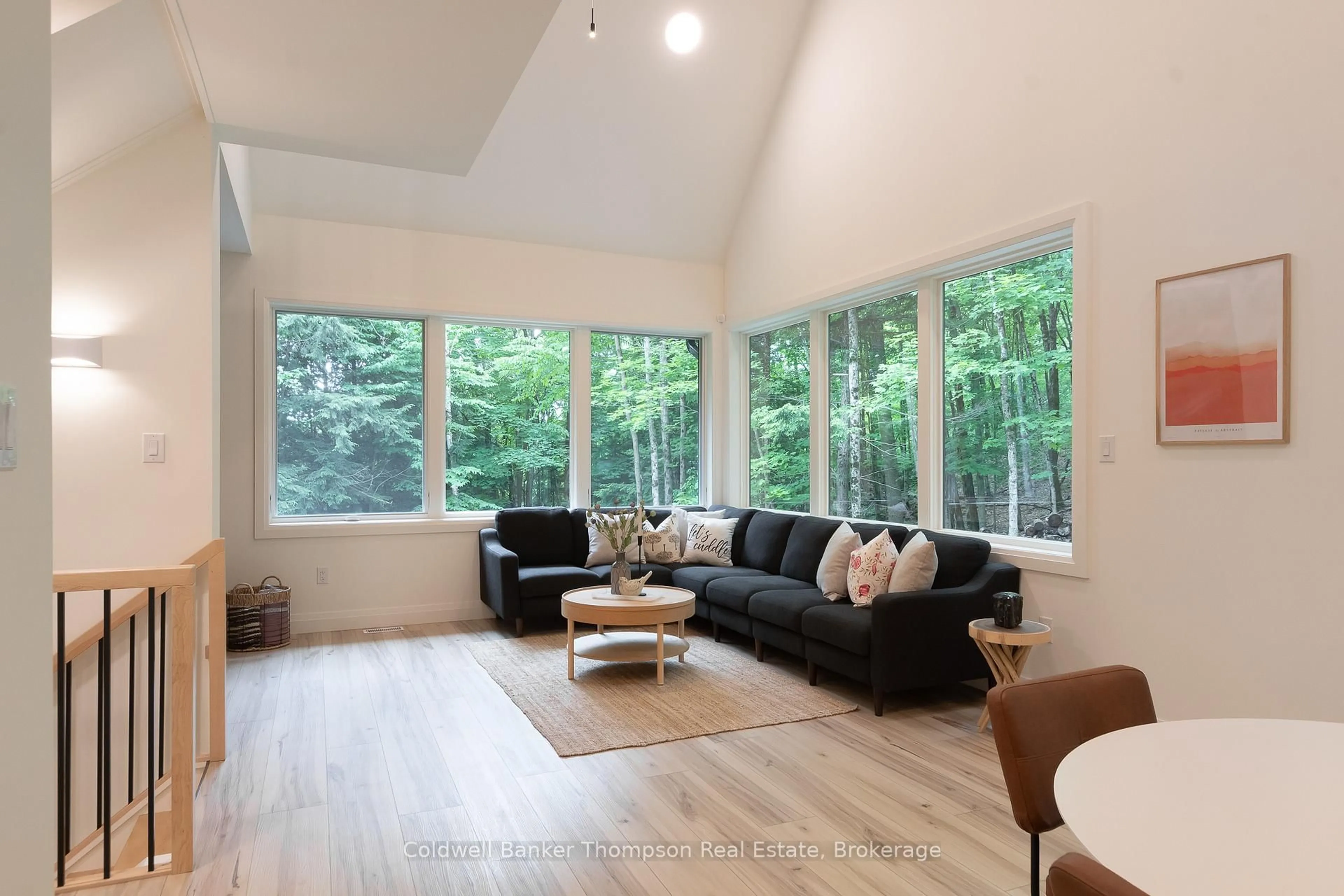 Living room with furniture, wood/laminate floor for 84 Vernon Lane, Huntsville Ontario P1H 2J2