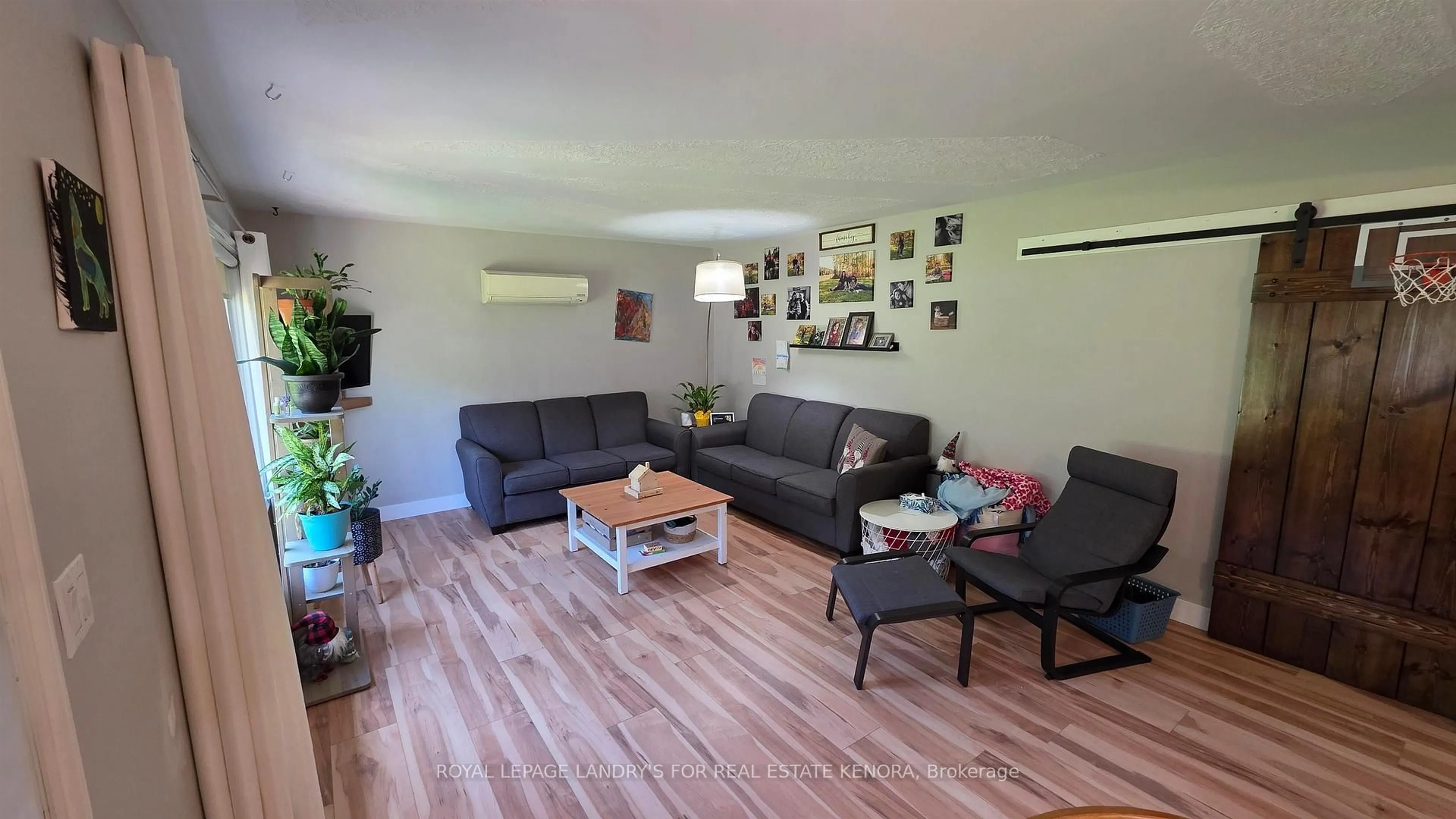 Living room with furniture, wood/laminate floor for 912 Ninth St, Kenora Ontario P9N 2T2