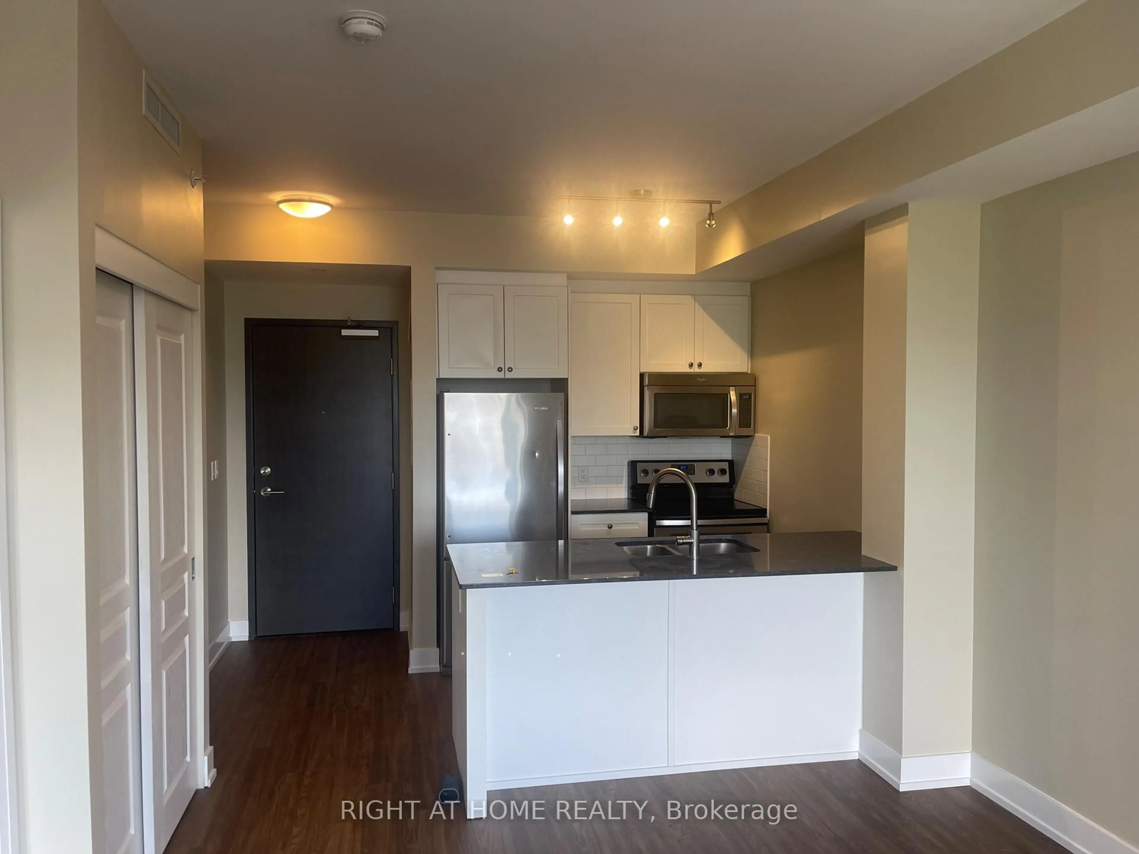 Open concept kitchen, wood/laminate floor for 118 Holmwood Ave #708, Ottawa Ontario K1S 5J5