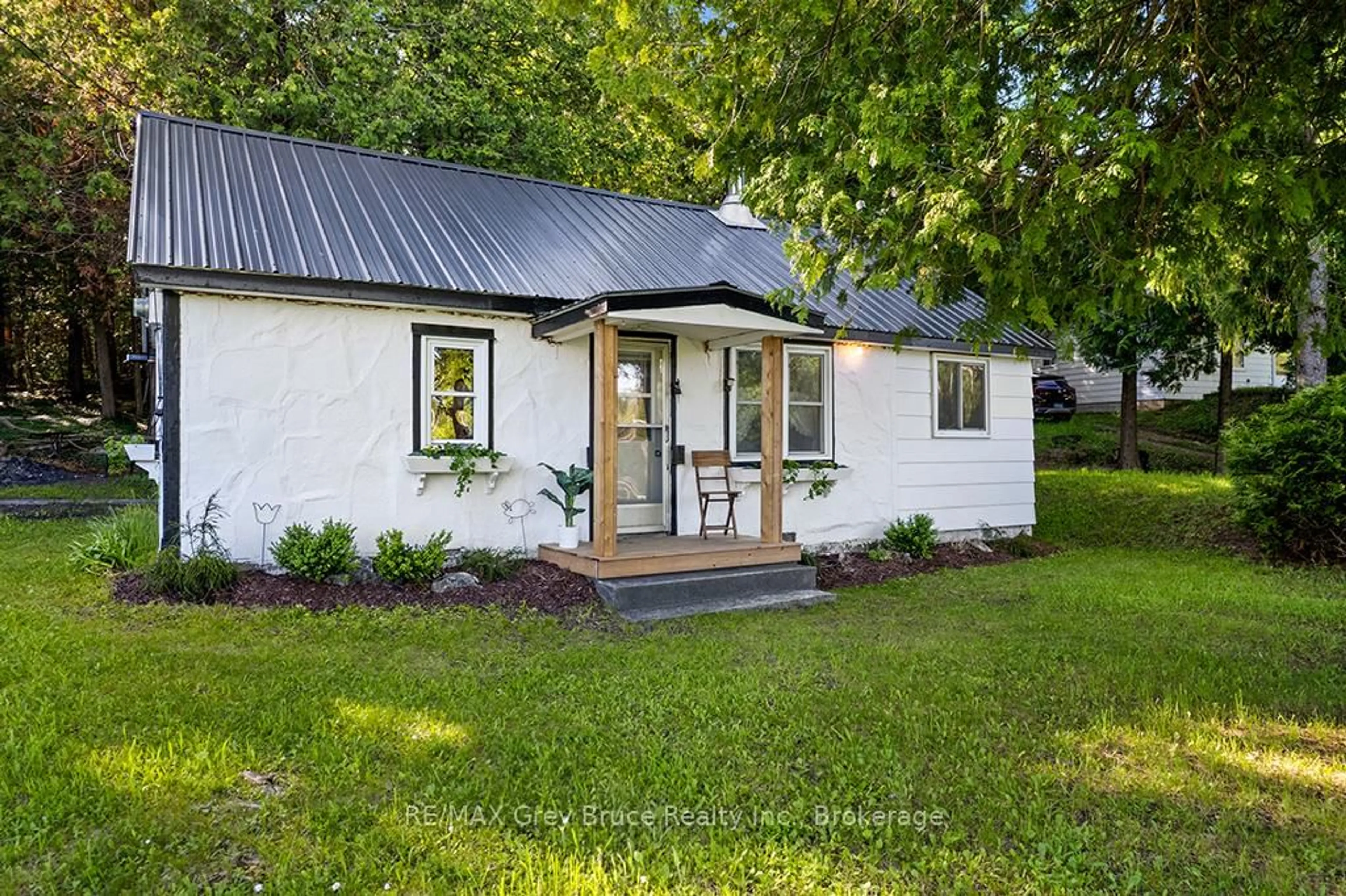 Home with vinyl exterior material, street for 609 Stokes Bay Rd, Northern Bruce Peninsula Ontario N0H 2M0