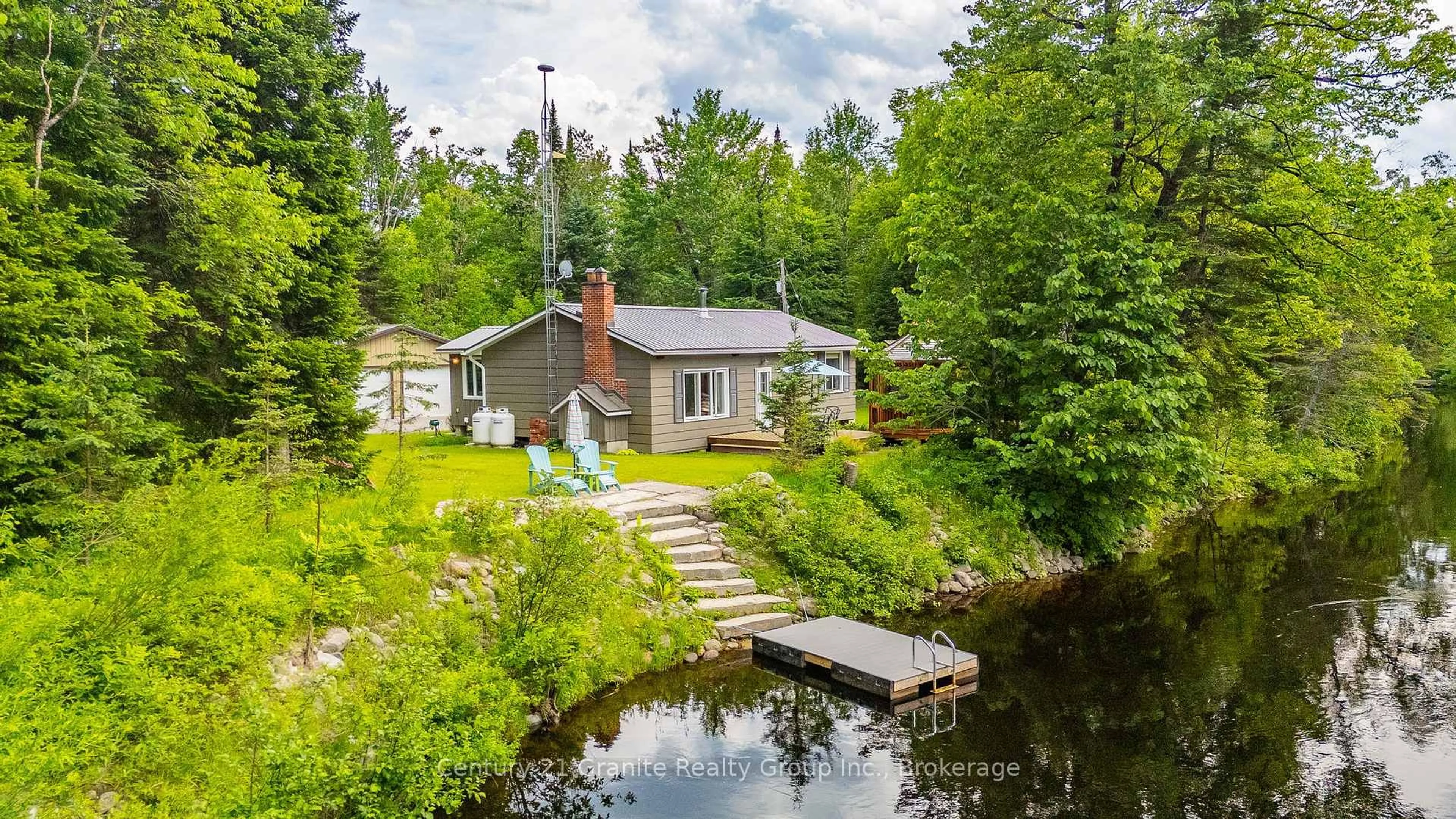A pic from outside/outdoor area/front of a property/back of a property/a pic from drone, water/lake/river/ocean view for 1075 Hobbits Lane, Minden Hills Ontario K0M 2A1