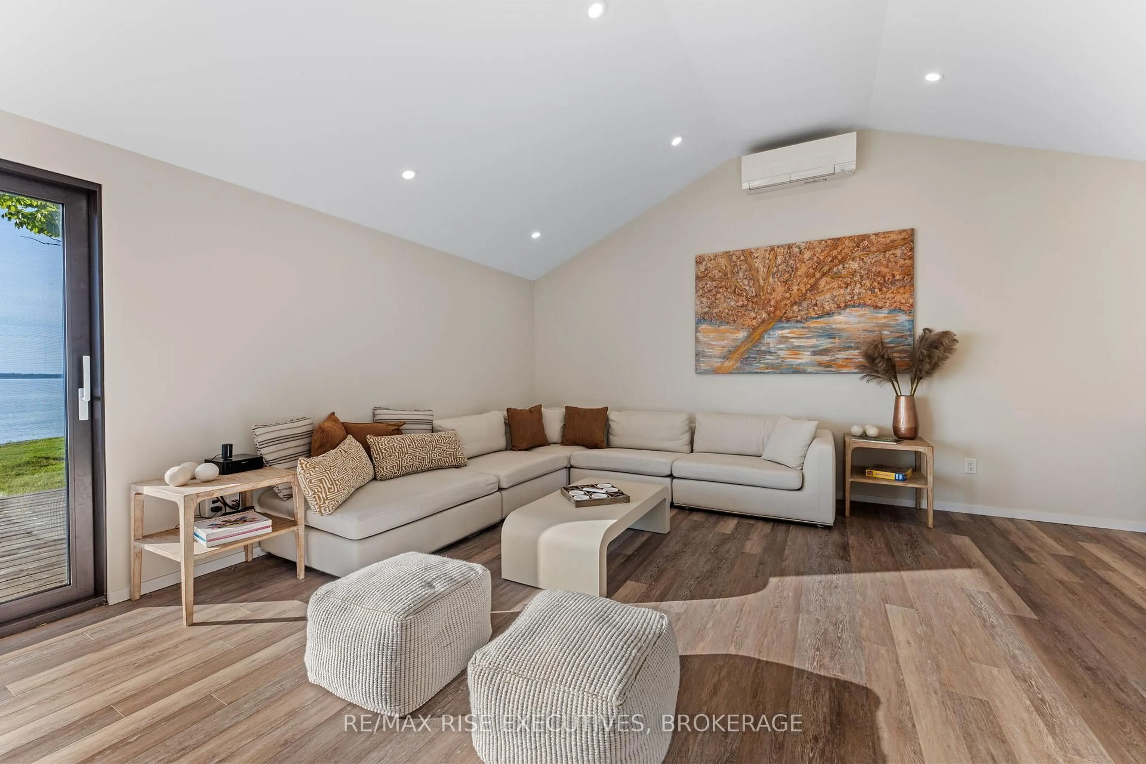 Living room with furniture, wood/laminate floor for 682 Salmon Point Rd, Prince Edward County Ontario K0K 1P0